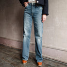 Image featuring a woman wearing the 90s High Rise Loose from Re/Done loose denim in a high rise, straight leg full length and a clean hem in comfort stretch denim.