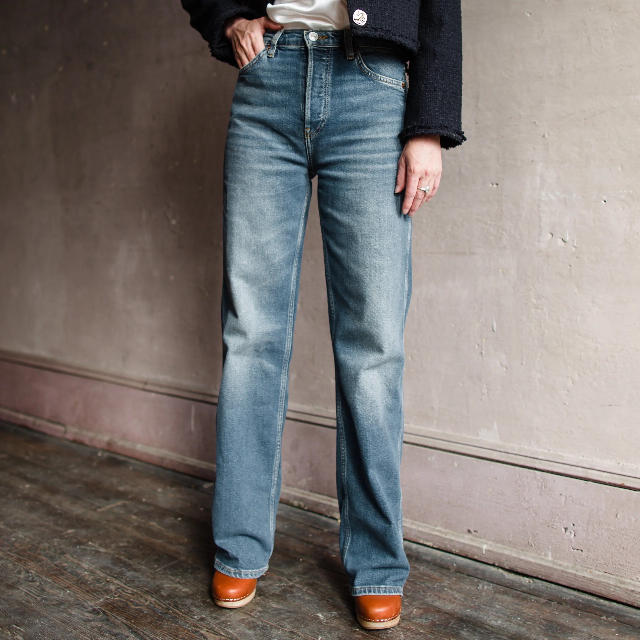 Image featuring a woman wearing the 90s High Rise Loose from Re/Done loose denim in a high rise, straight leg full length and a clean hem in comfort stretch denim.