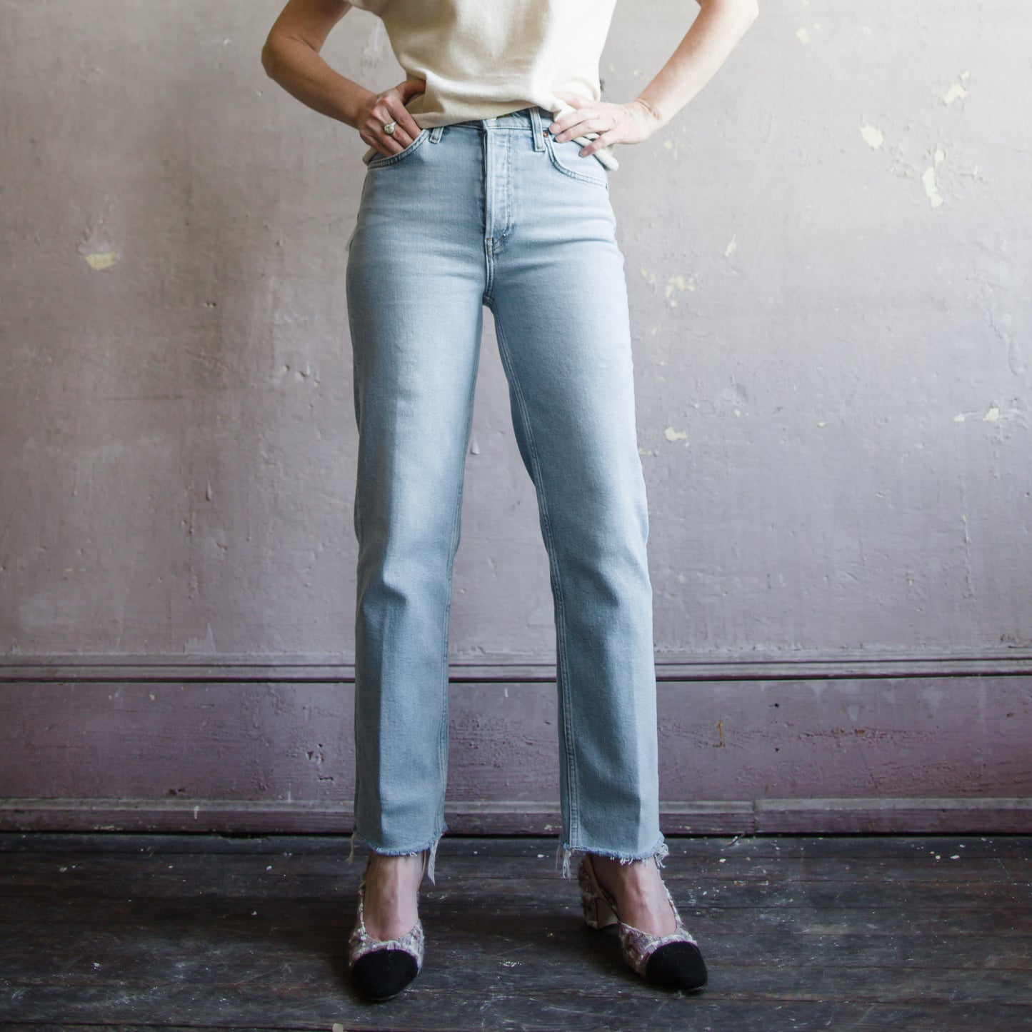 Image featuring a woman wearing Re/Done 70's denim straight leg jean with cropped inseam; in comfort stretch denim, a classic button fly, and a raw hem.