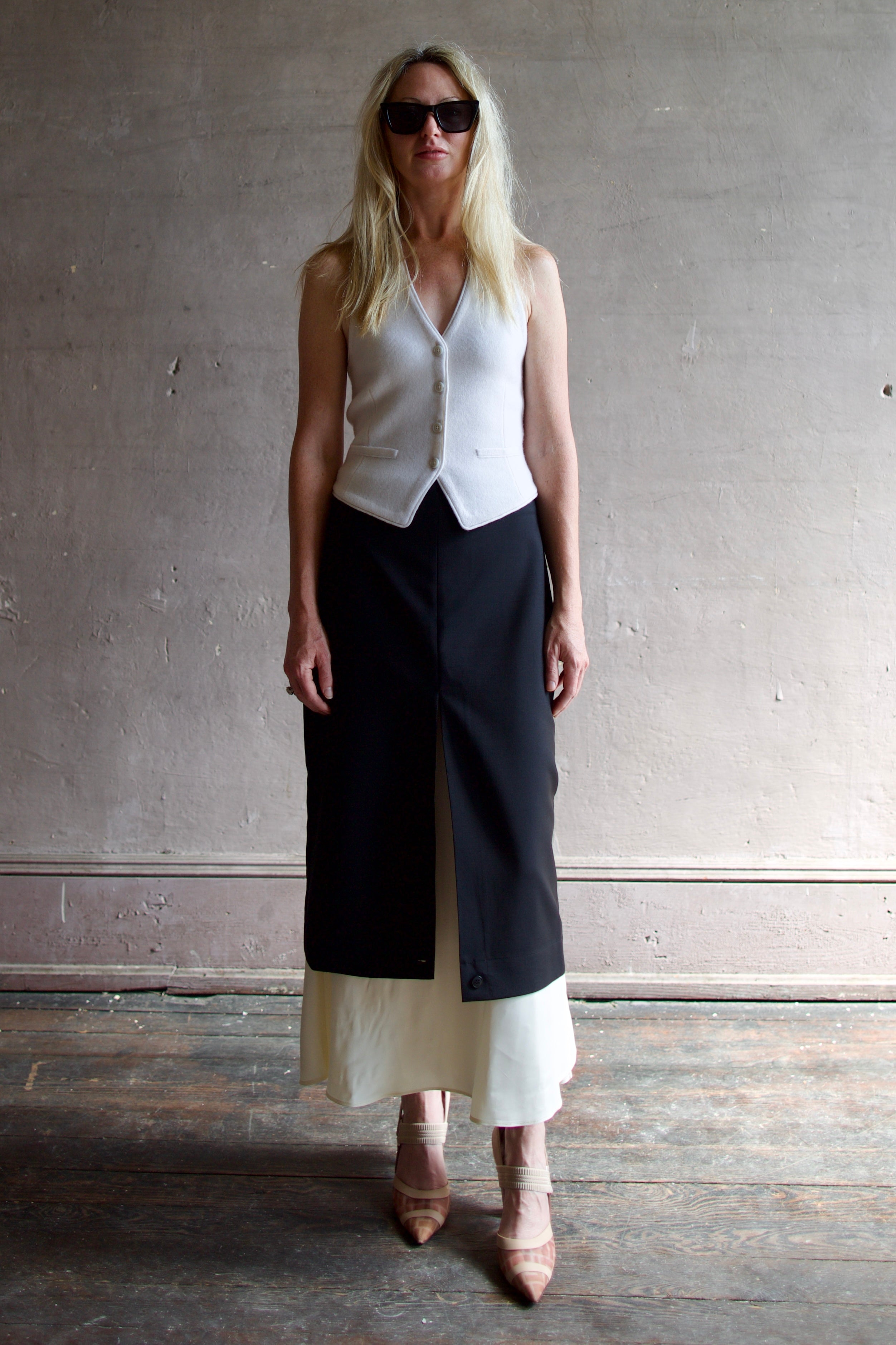 Model wearing modern Amsterdam designer Rohe contrast upside down skirt in black with luxury classic tailoring