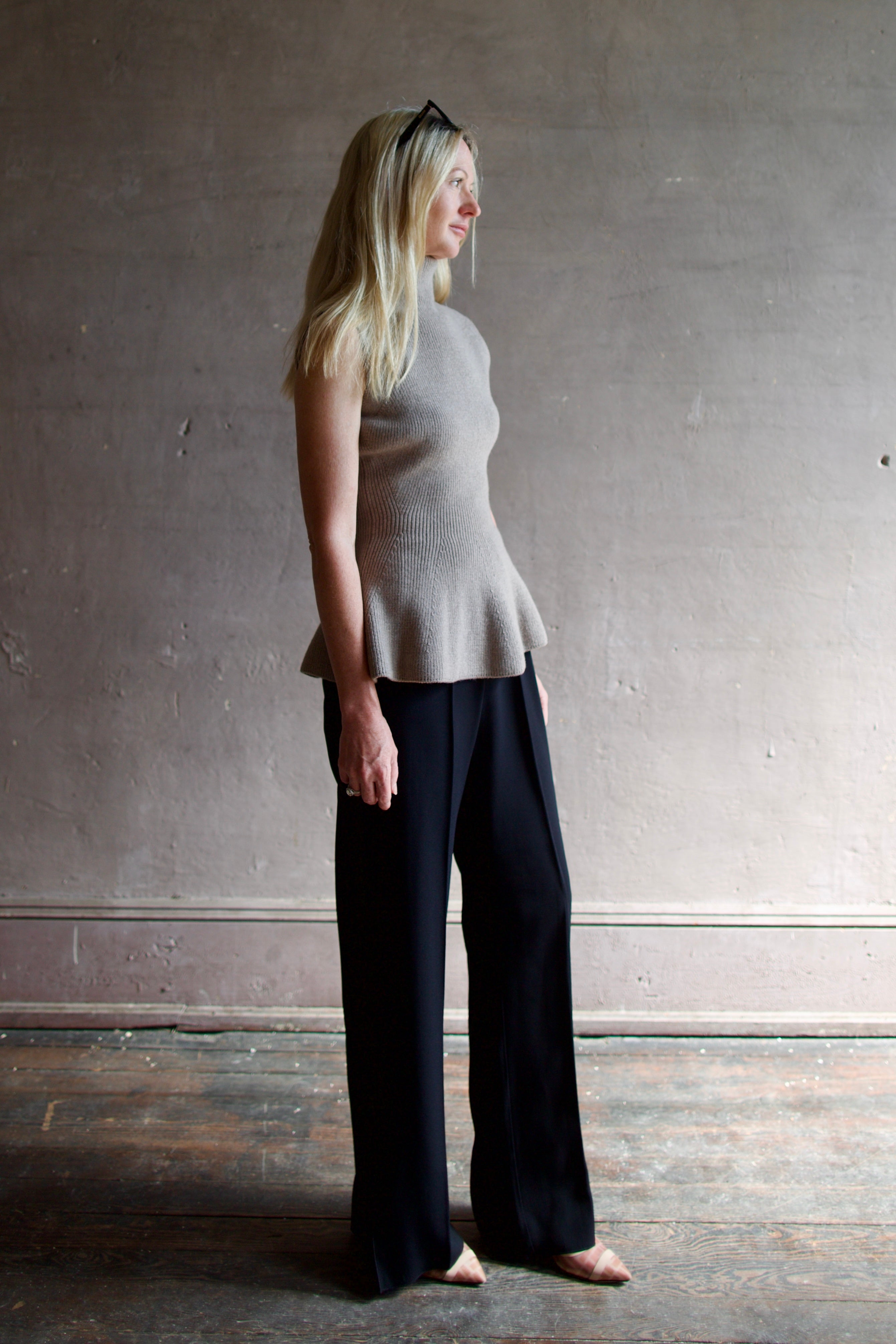 Model wearing luxury Rohe sculptural sleeveless knitted top with refined sophisticated modern silhouette for premium quality neutral taupe top