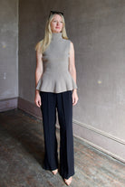 Model wearing luxury brand Rohe sculptural sleeveless knitted top with refined sophisticated modern silhouette for premium quality minimalist