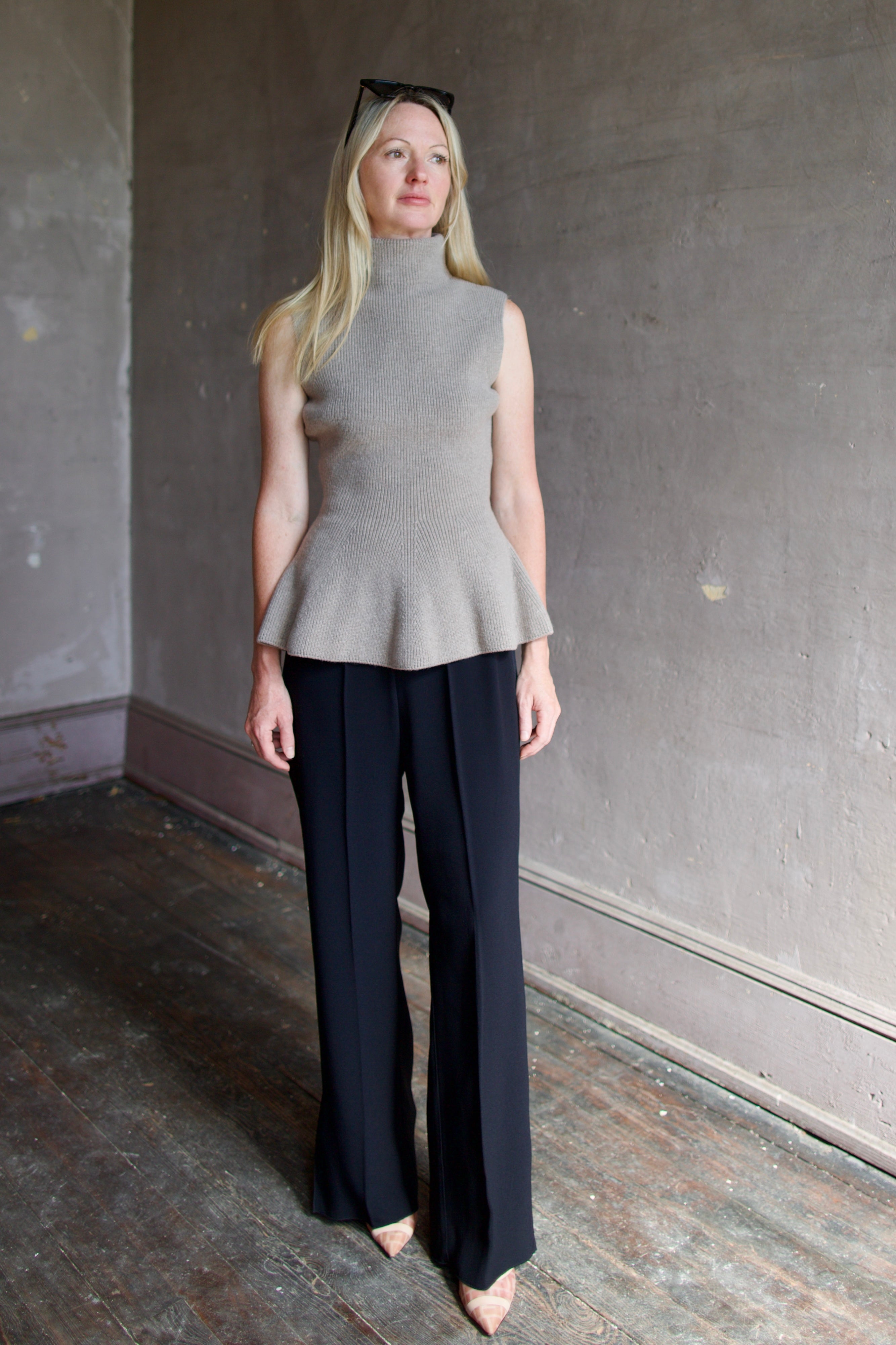 Model wearing luxury brand Rohe sculptural sleeveless knitted top with refined sophisticated modern silhouette for premium quality minimalist