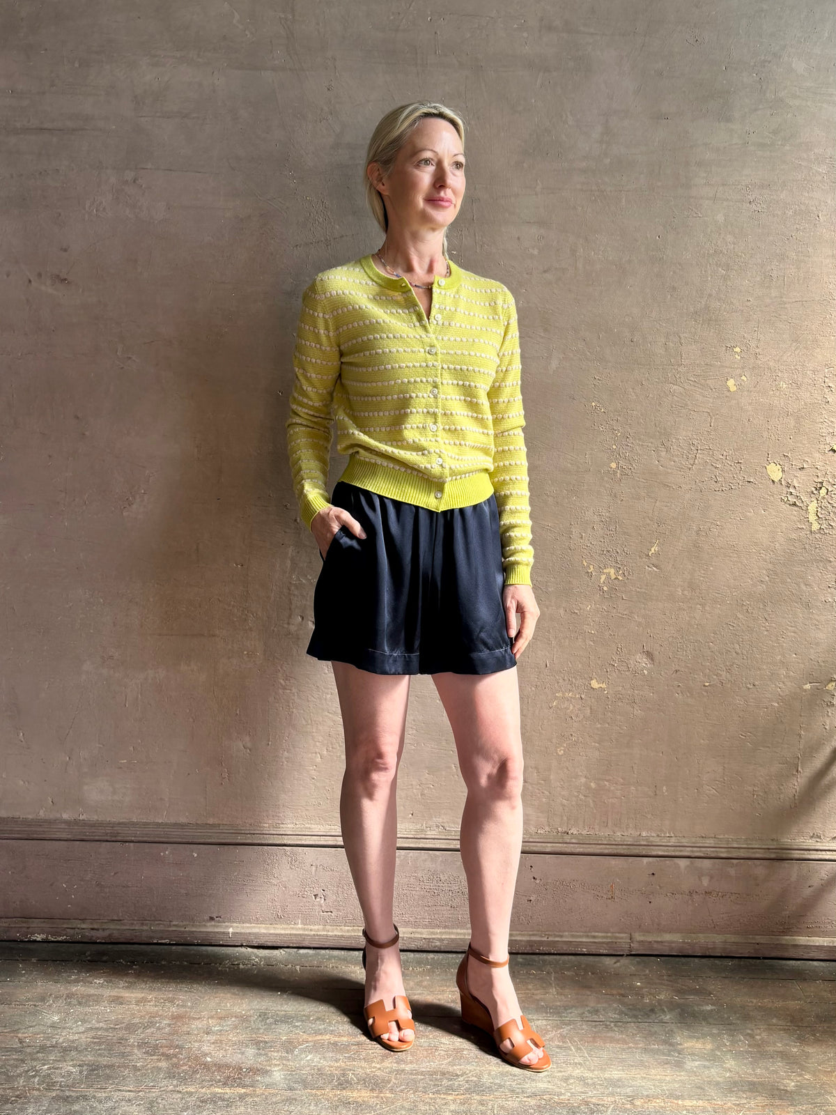 Mature woman wearing Sablyn's Brynn Silk Shorts in Navy Blue pull-on wide leg effortlessly elevated