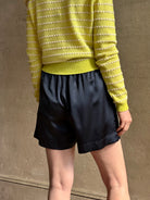Mature woman wearing Sablyn's Brynn Silk Shorts in Navy Blue pull-on wide leg with pockets effortlessly elevated
