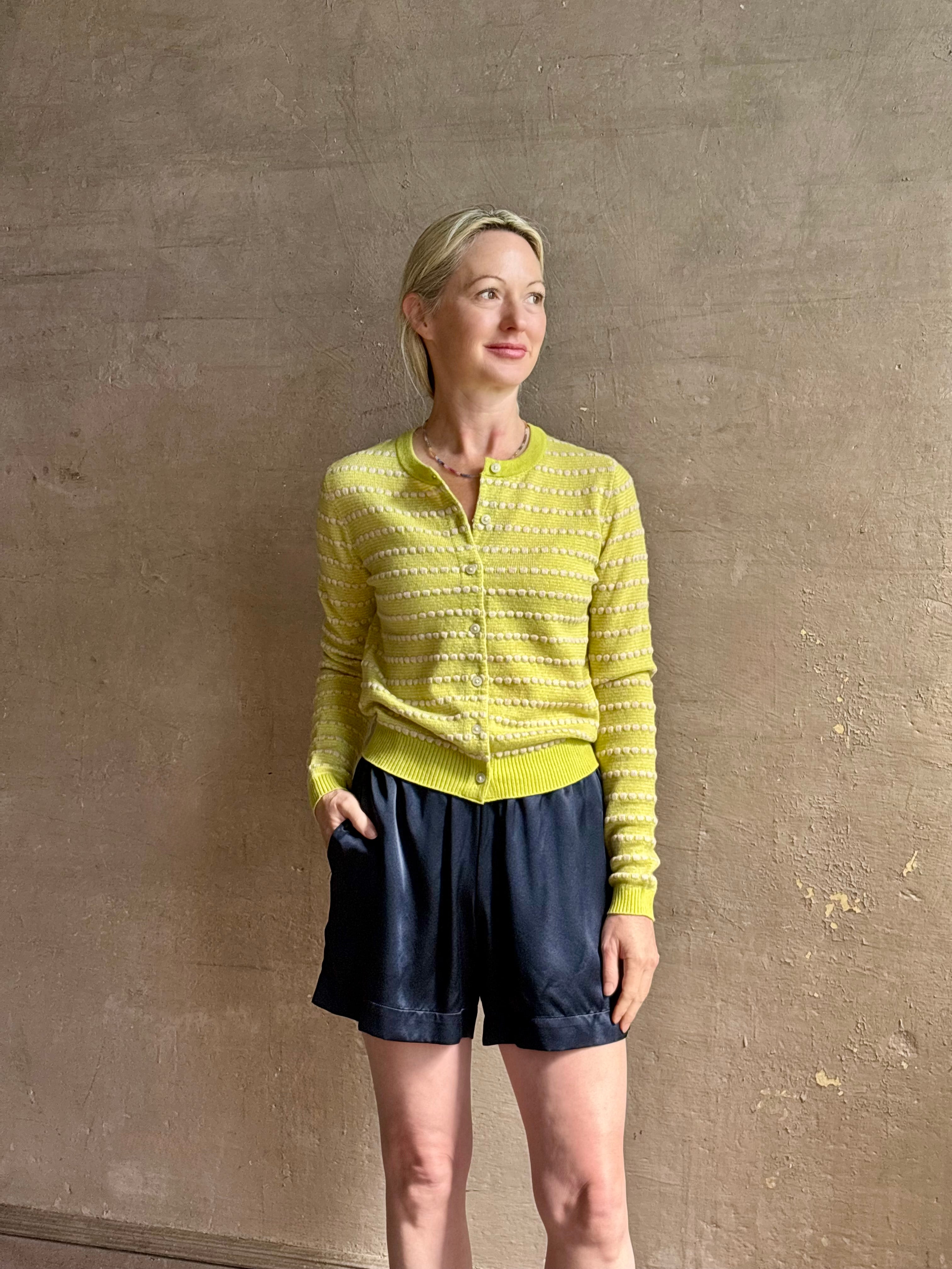 Mature woman wearing Sablyn's Brynn Silk Shorts in Navy Blue pull-on wide leg with side pockets effortlessly elevated