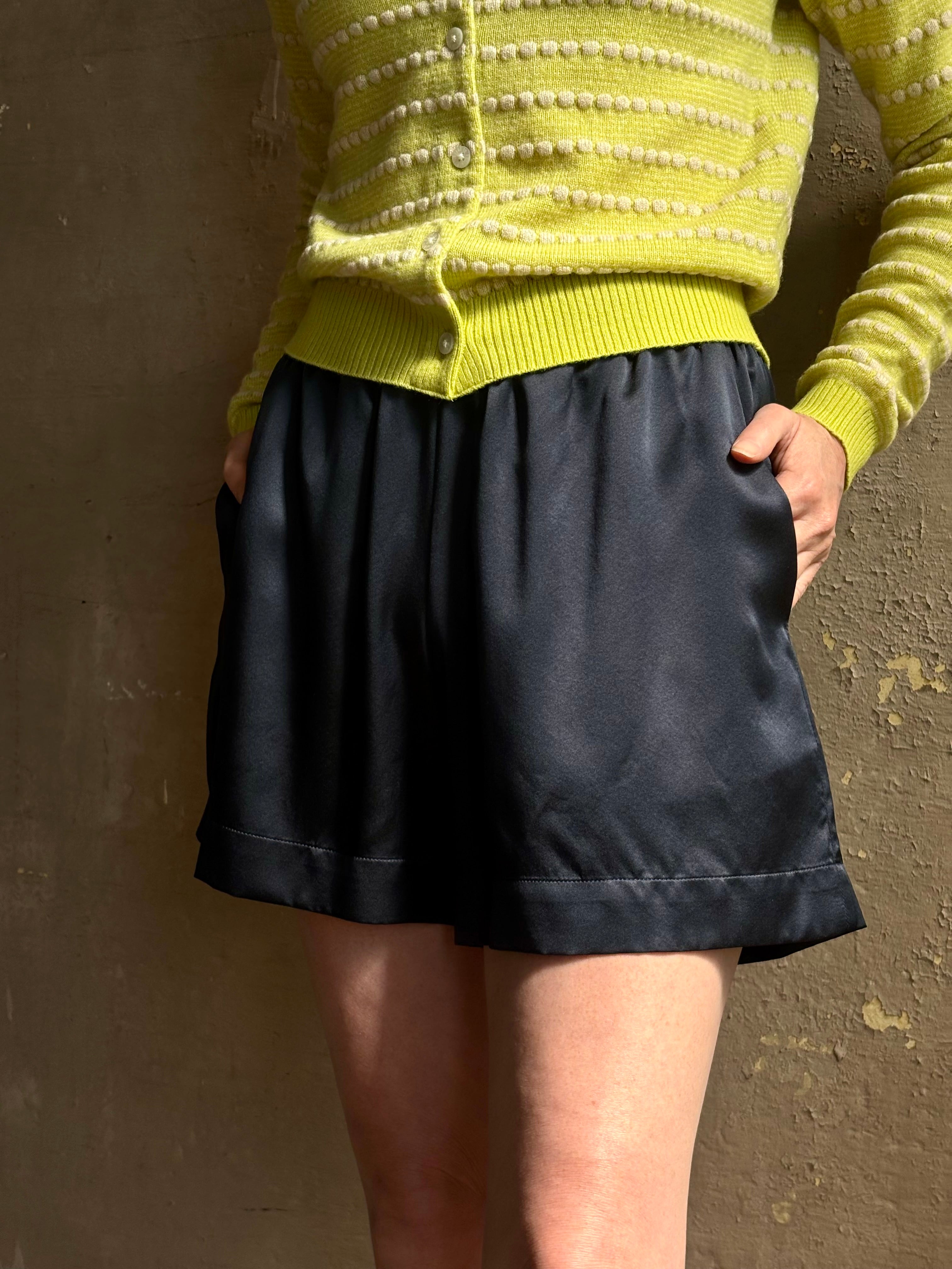 Mature woman wearing Sablyn's Brynn Silk Shorts in Navy Blue pull-on wide leg effortlessly elevated