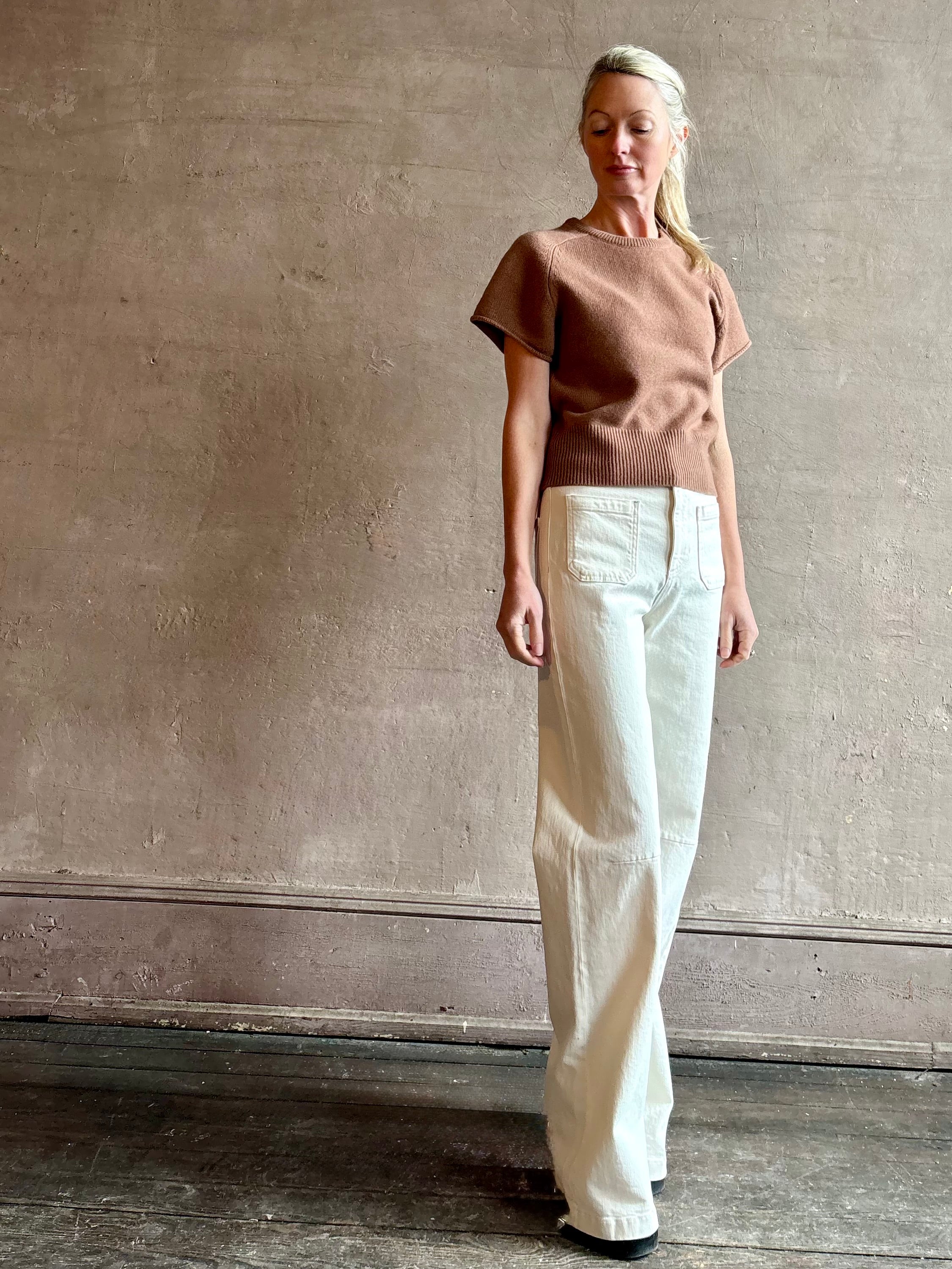 Woman wearing luxury women's brand SABLYN Jones Saddle Raglan Cashmere Sweater with crew neck and fitted waistband