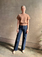 Woman wearing elegant luxury brand SABLYN Jones Saddle Raglan Cashmere Sweater neutral copper tone
