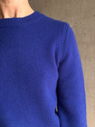 Mature woman wearing a vibrant cobalt blue Sablyn crewneck knit shrunken crewneck long sleeve cashmere sweater 
