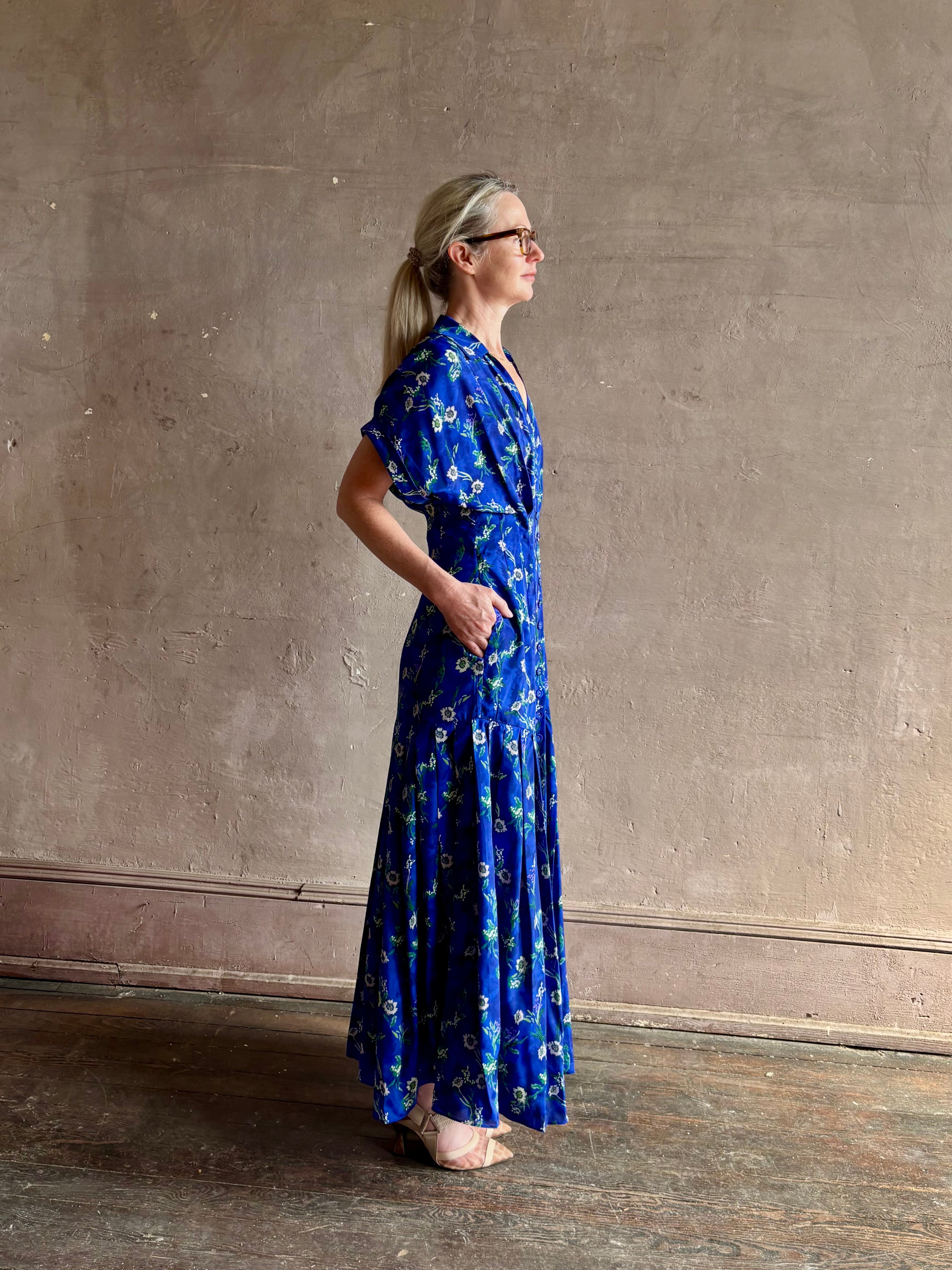 Woman wearing Saloni silk maxi Riya dress with short sleeves bouson top drop waist v-neck button front cobalt