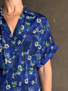 Woman wearing Saloni silk maxi Riya dress with short sleeves bouson top drop waist v-neck button front cobalt