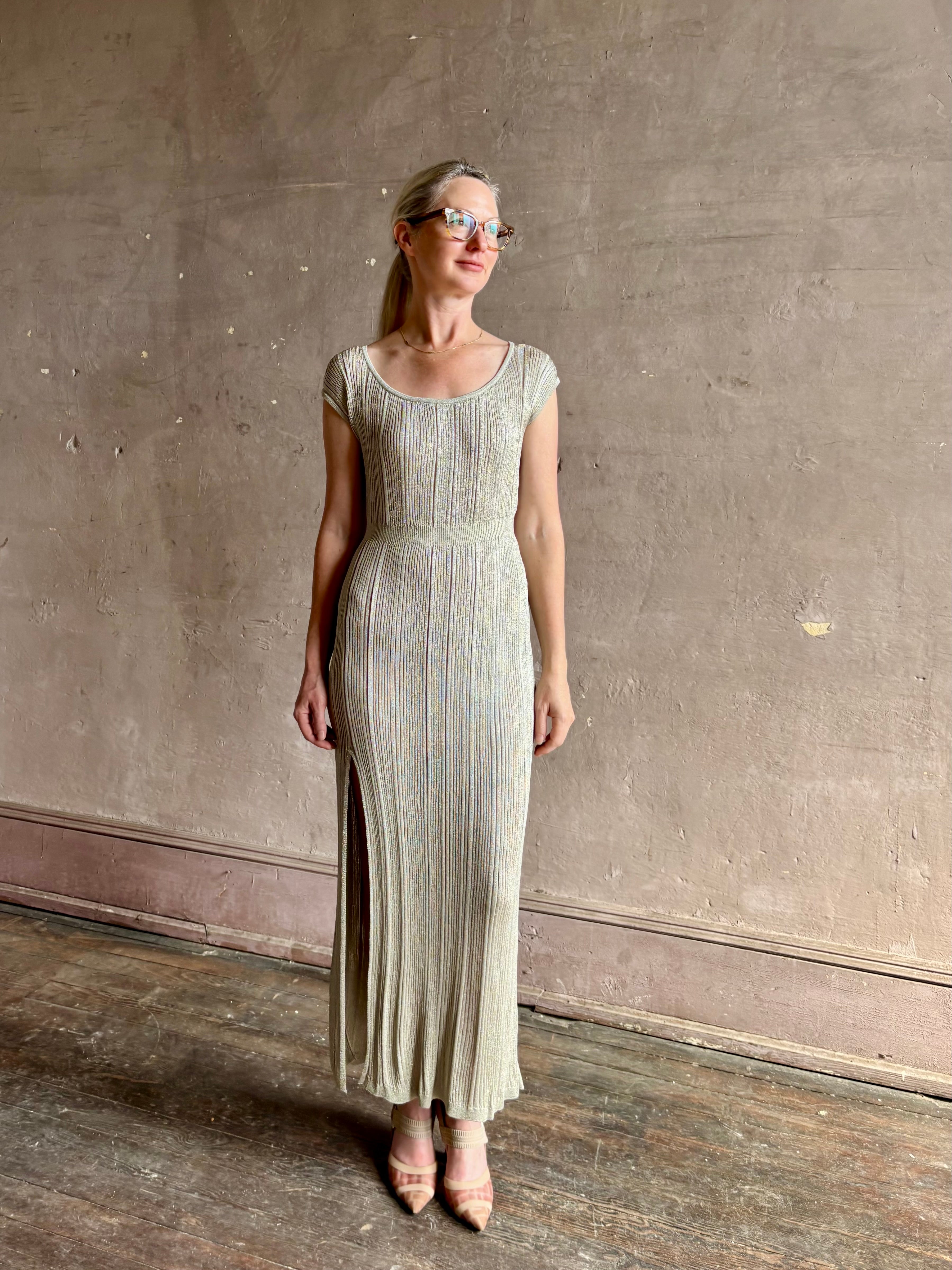 woman wearing saloni stardust cap sleeve floor-length ribbed knit dress front leg vent round neck fitted silver metallic