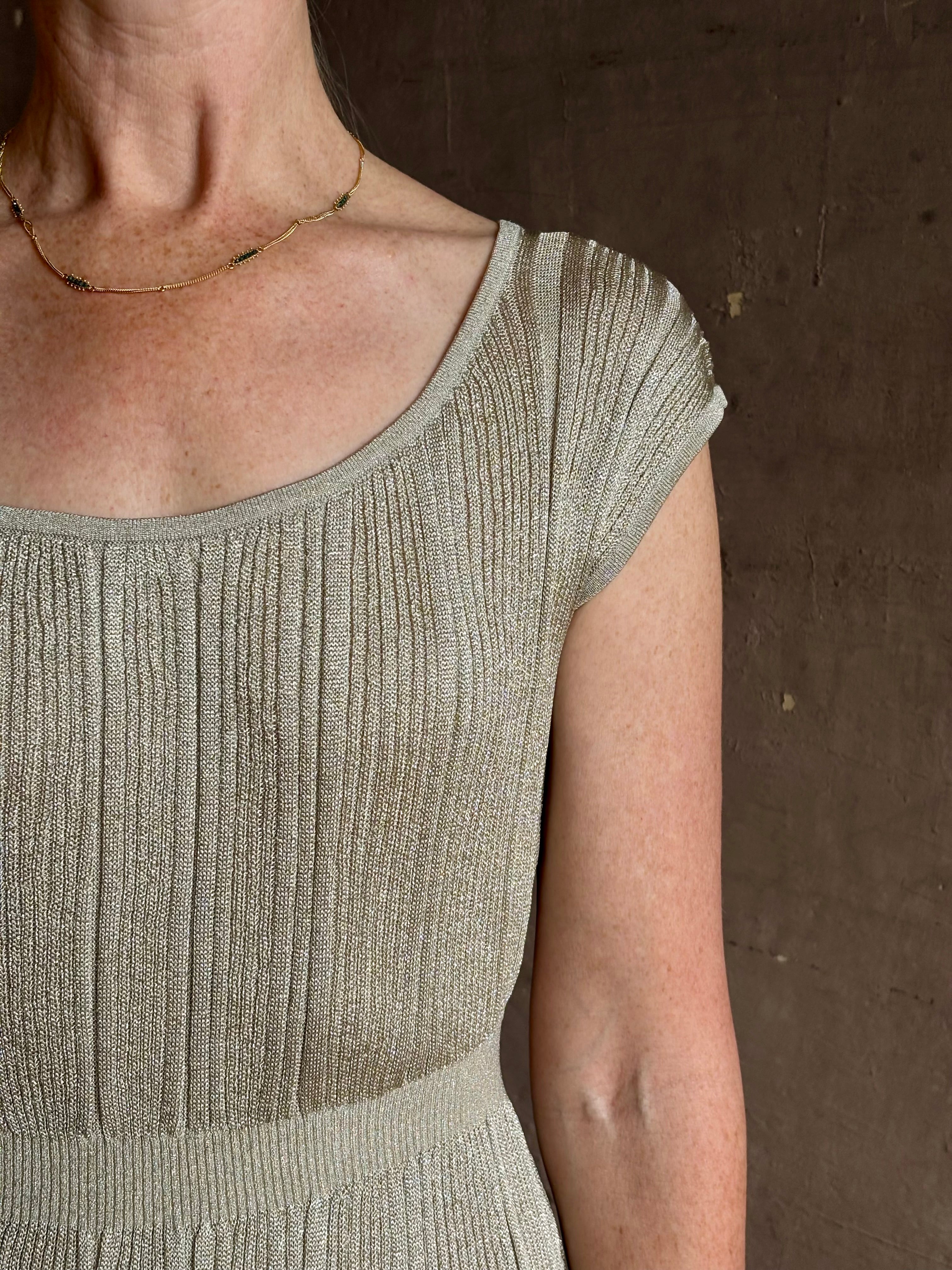 woman wearing saloni stardust cap sleeve floor-length ribbed knit dress front leg vent round neck fitted silver 