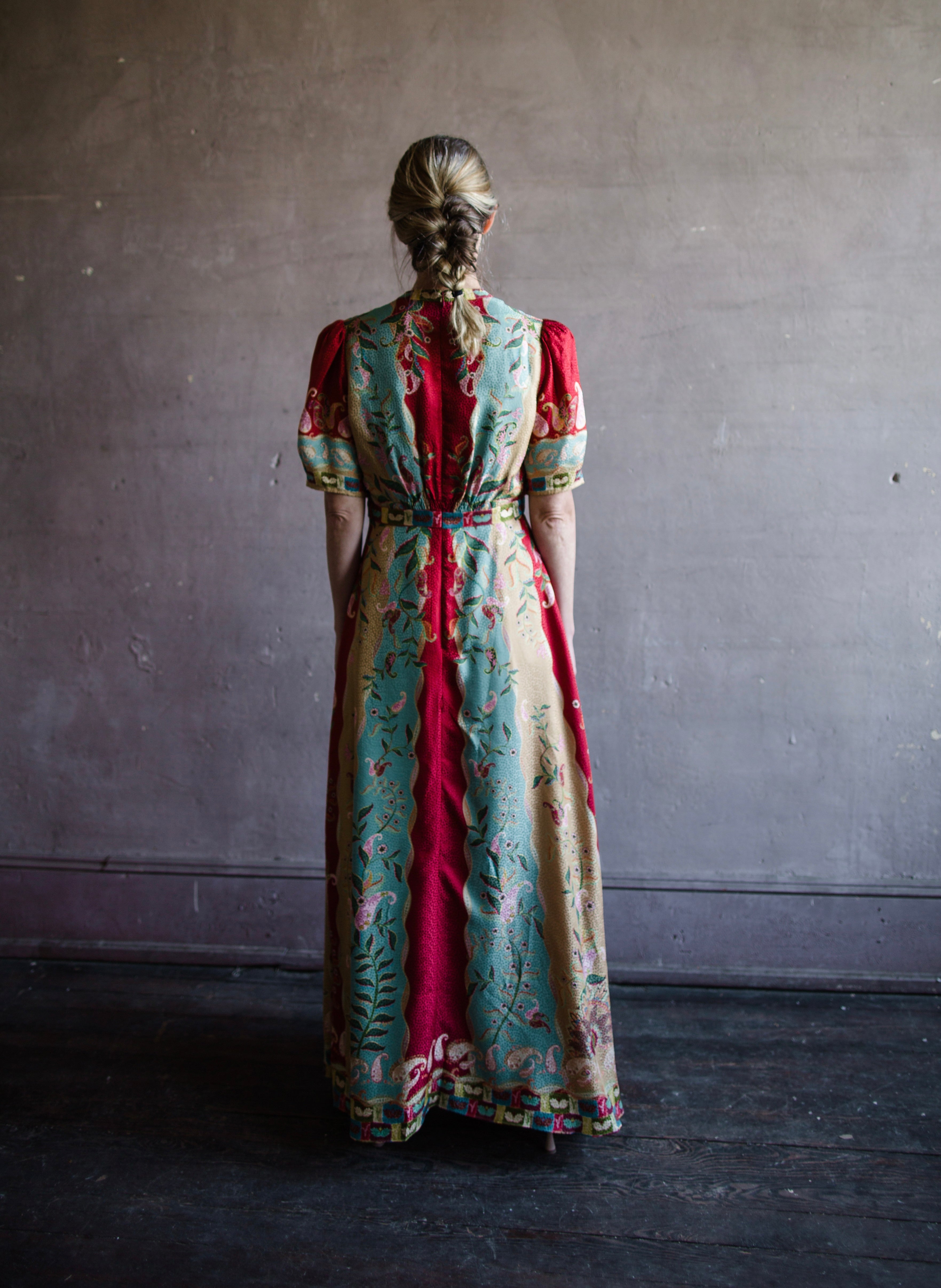 Mature woman wearing Saloni Tabitha silk maxi dress v-neck short sleeves empire waist red yellow aqua floral 