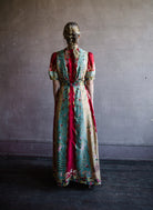 Mature woman wearing Saloni Tabitha silk maxi dress v-neck short sleeves empire waist red yellow aqua floral 