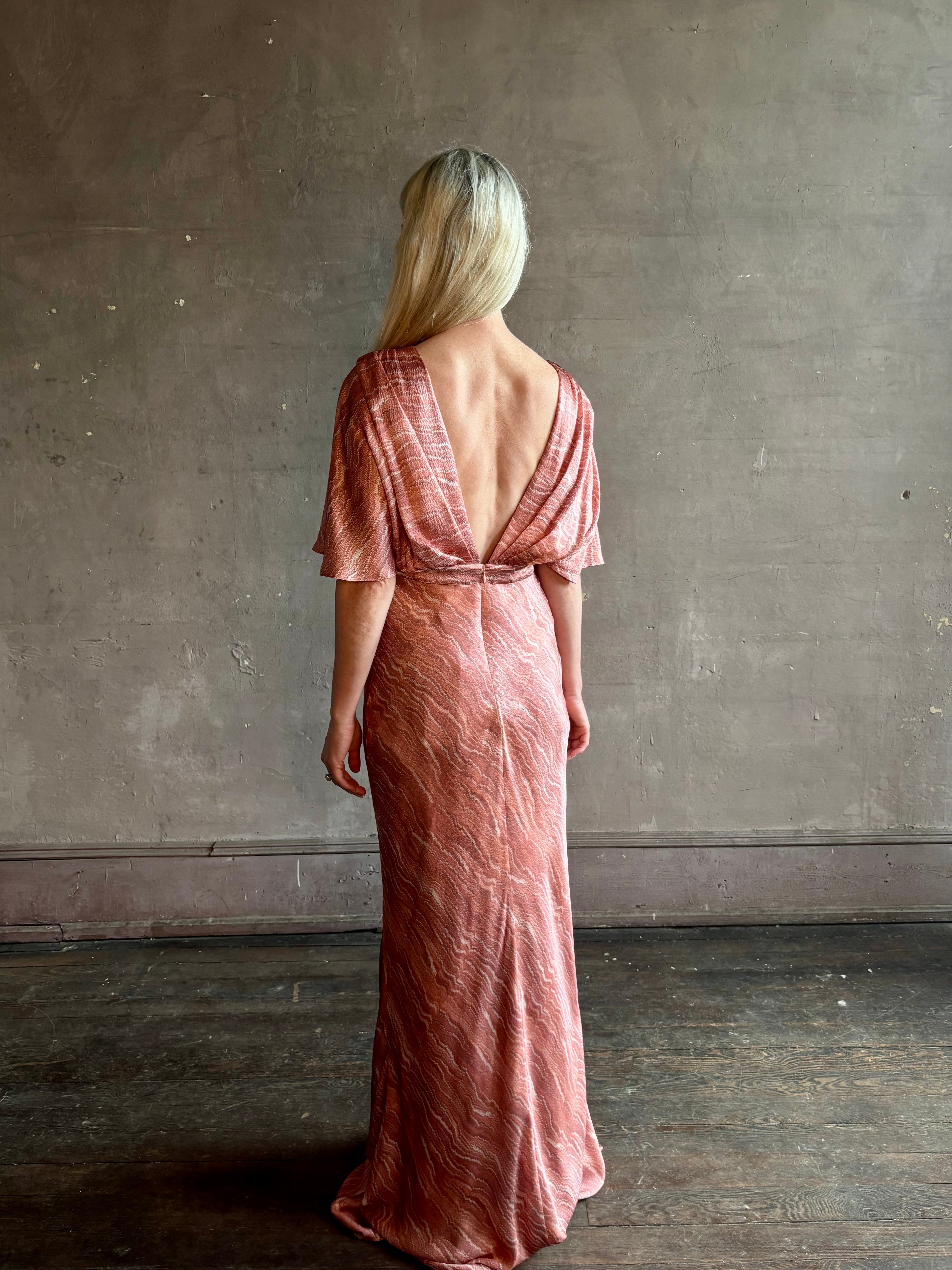 Mature woman wearing Saloni silk Winona Dress in Blush Marbling print V-back detail short sleeves empire waist Romantic occasion gown