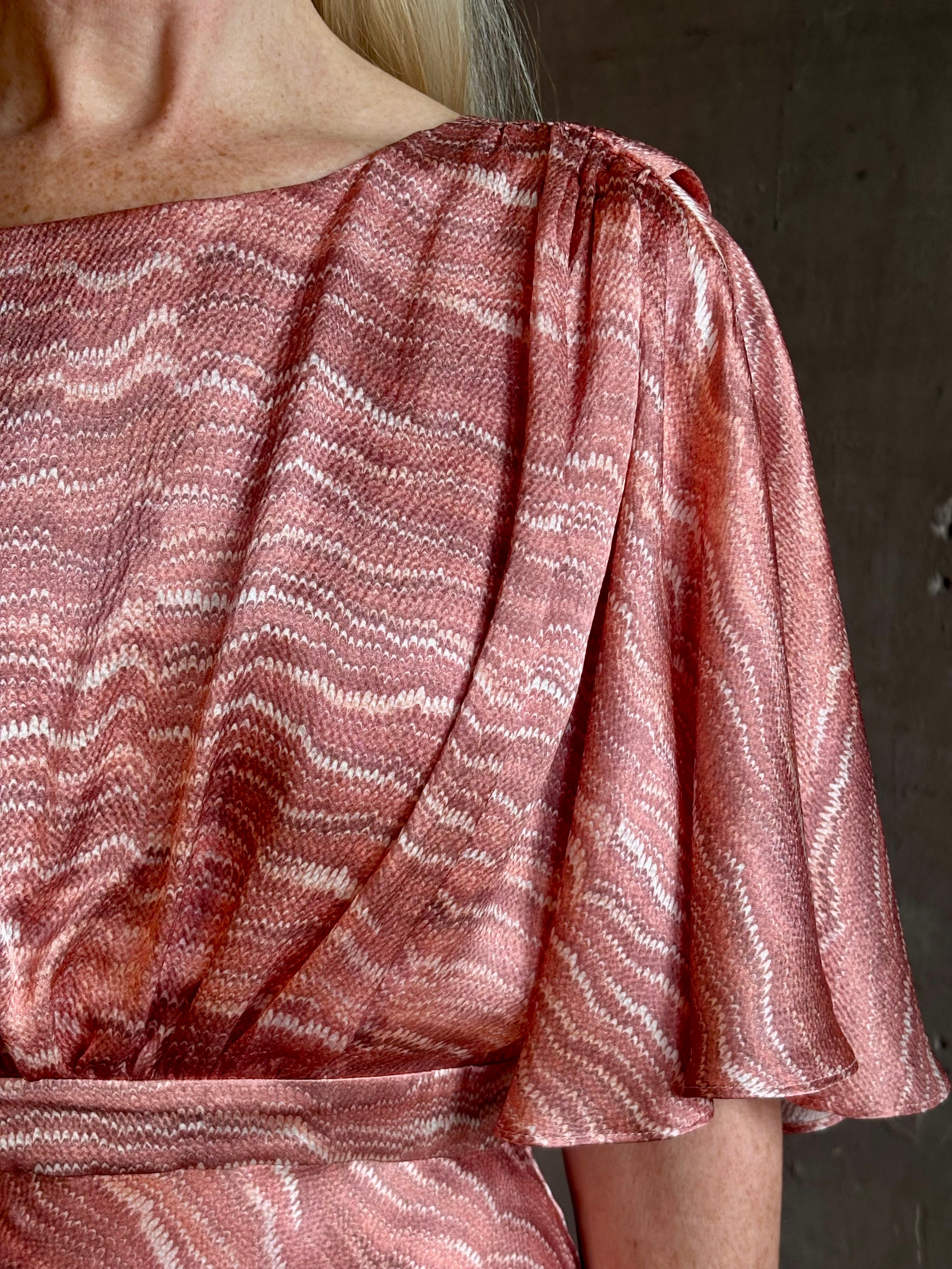 Mature woman wearing Saloni silk Winona Dress in Blush Marbling print V-back detail short sleeves empire waist Romantic occasion gown