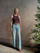 Mature woman wearing Slvrlake Grace Ankle ridgid cotton jeans with a high rise zipper wide leg ankle length light wash 