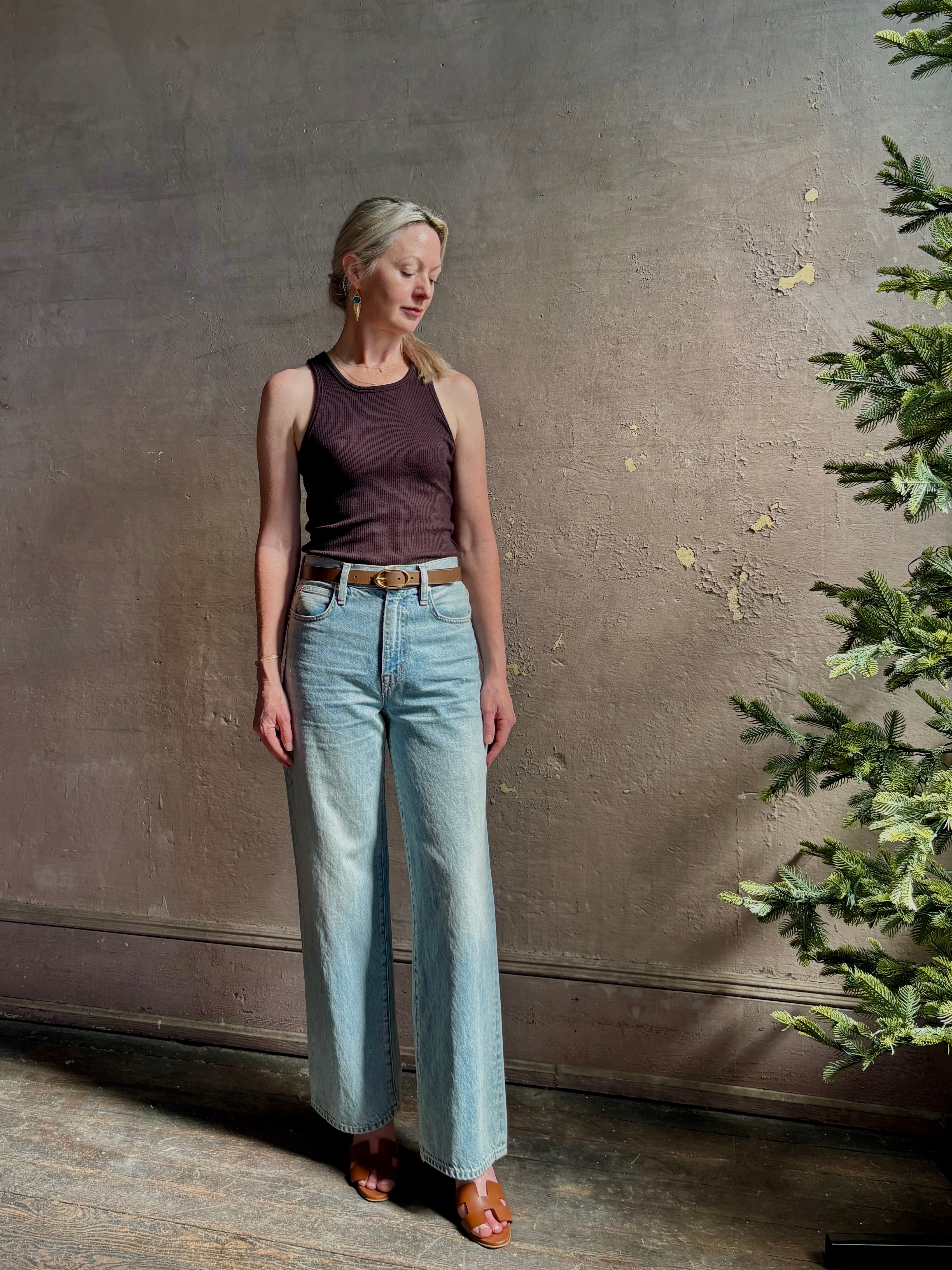 Mature woman wearing Slvrlake Grace Ankle ridgid cotton jeans with a high rise zipper wide leg ankle length light wash 