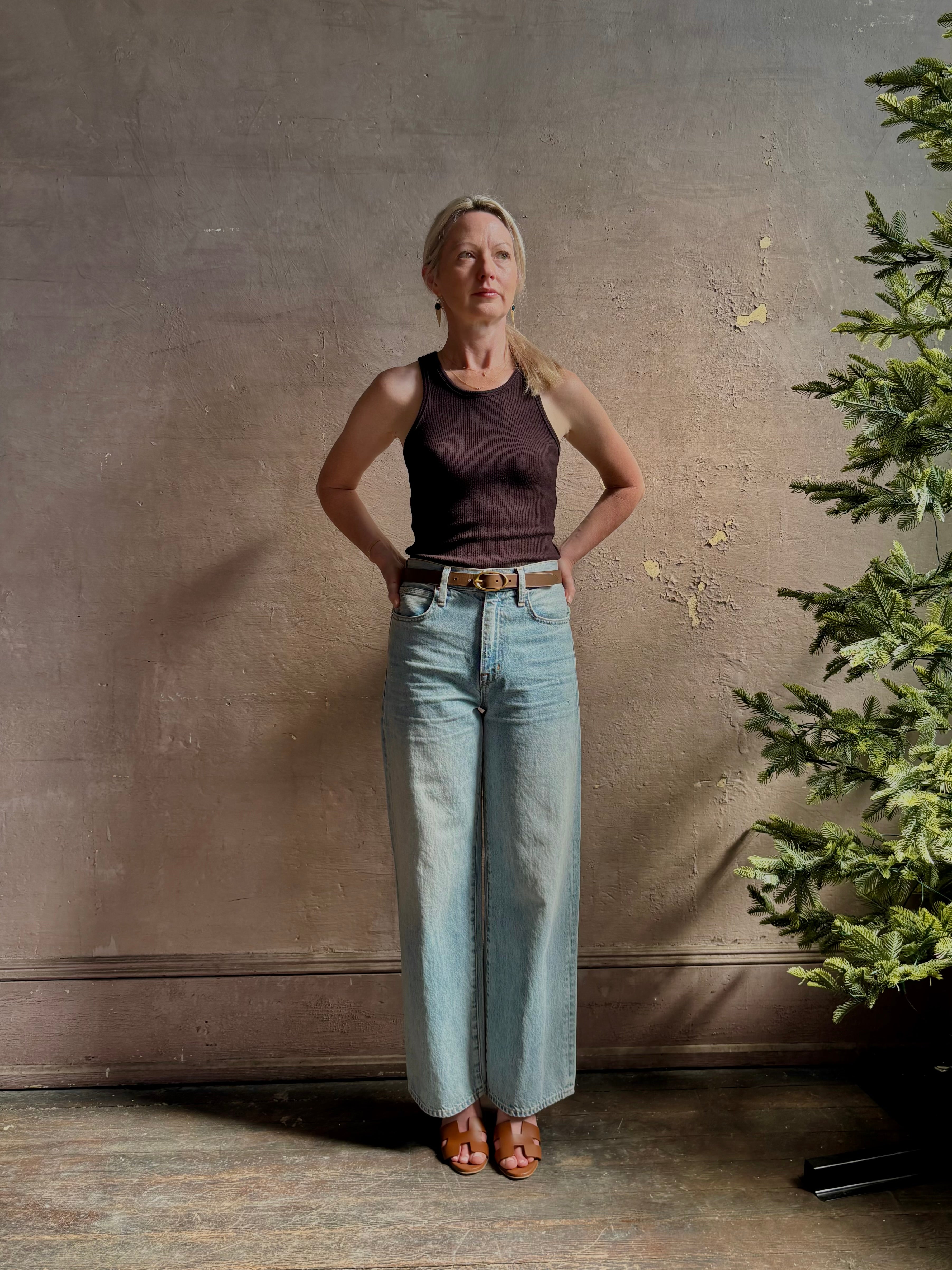 Mature woman wearing Slvrlake Grace Ankle ridgid cotton jeans with a high rise zipper wide leg ankle length light wash 