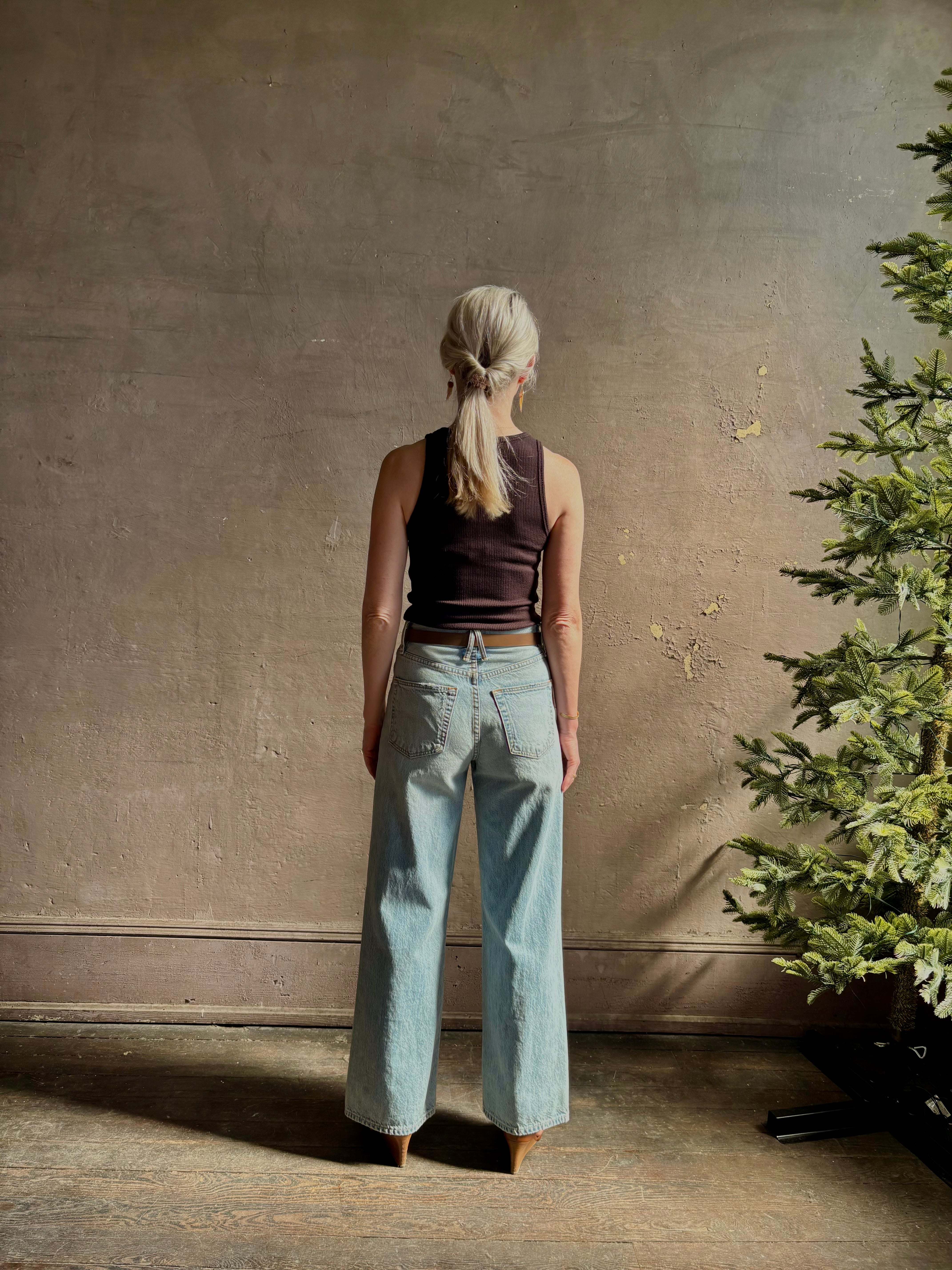 Mature woman wearing Slvrlake Grace Ankle ridgid cotton jeans with a high rise zipper wide leg ankle length light wash 