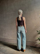 Mature woman wearing Slvrlake Grace Ankle ridgid cotton jeans with a high rise zipper wide leg ankle length light wash 
