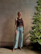 Mature woman wearing Slvrlake Grace Ankle ridgid cotton jeans with a high rise zipper wide leg ankle length light wash 