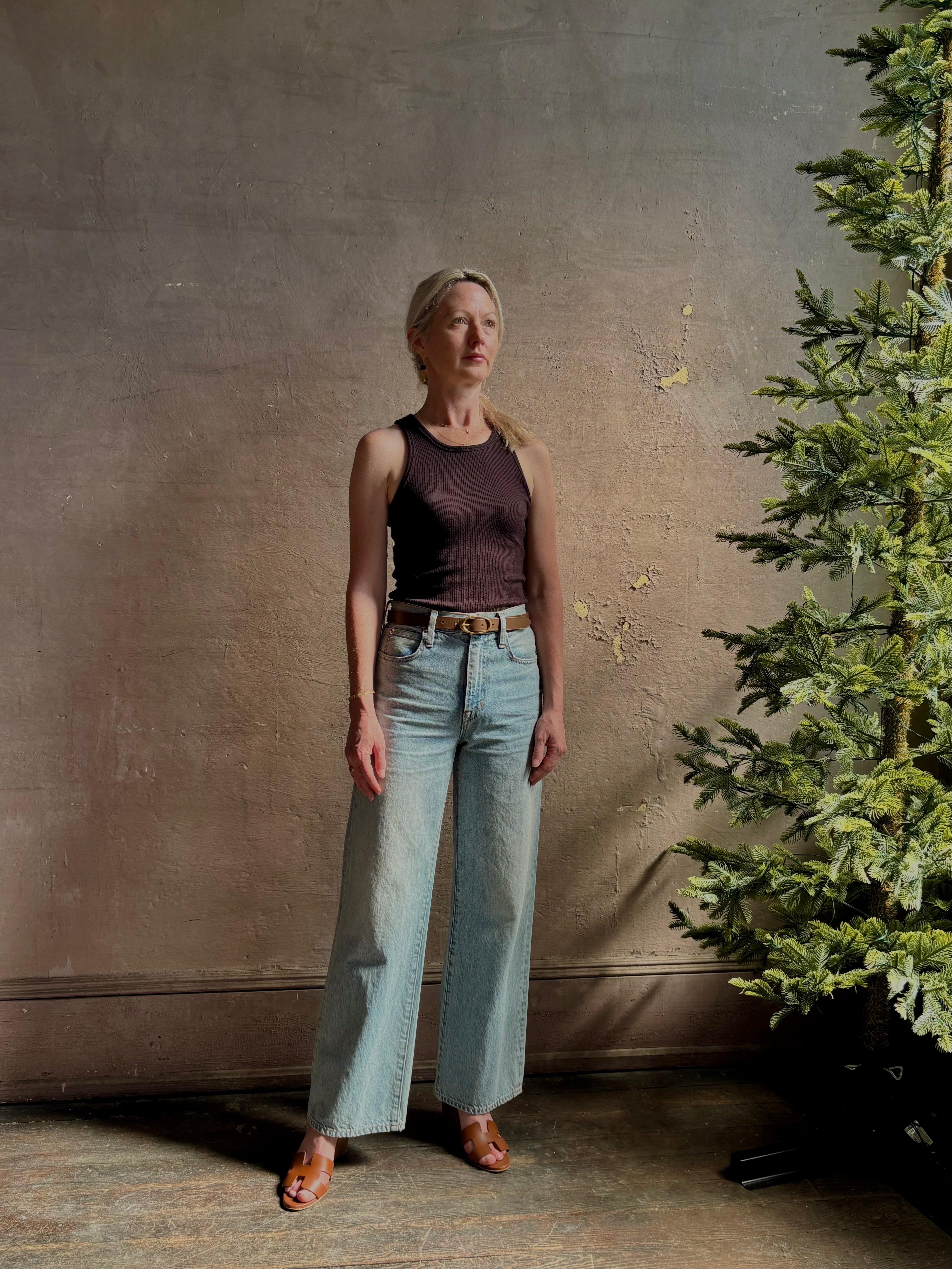 Mature woman wearing Slvrlake Grace Ankle ridgid cotton jeans with a high rise zipper wide leg ankle length light wash 