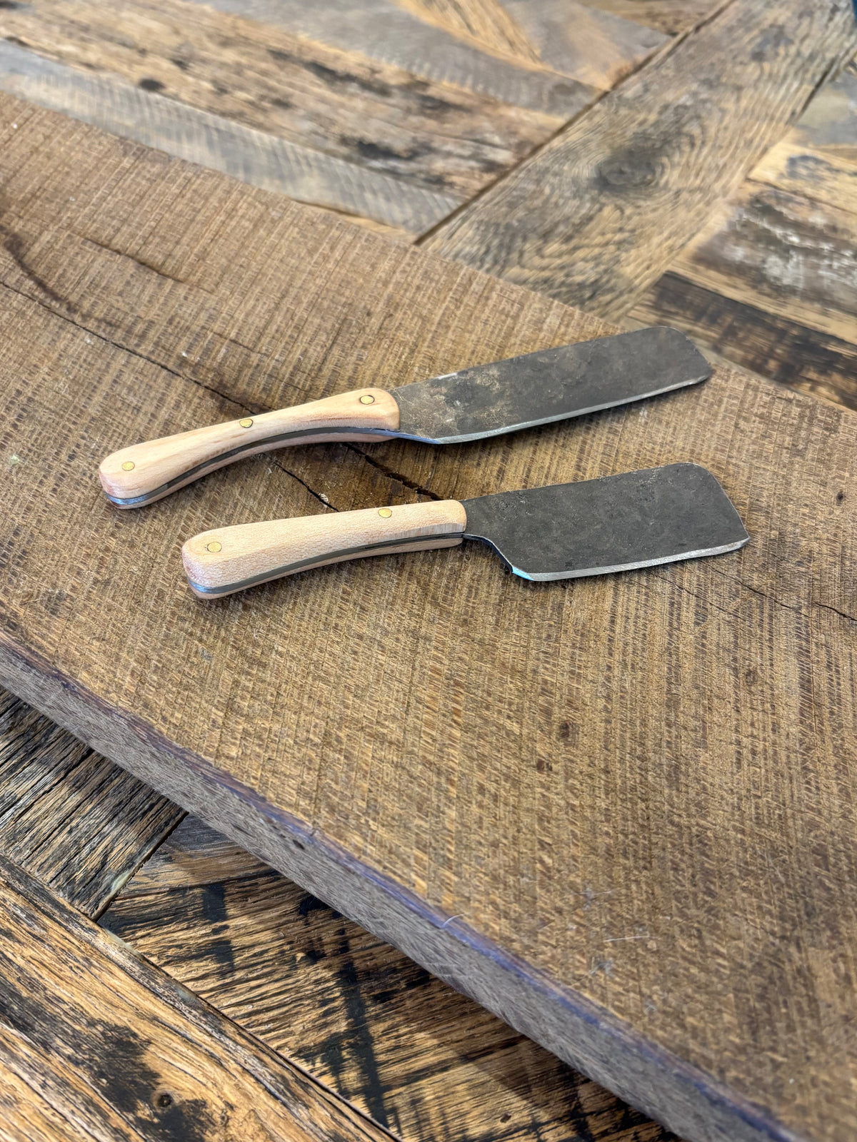 A small and large rustic modern charcuterie serving knife set with hand-forged steel blade and maple wooden handle hand crafted in USA