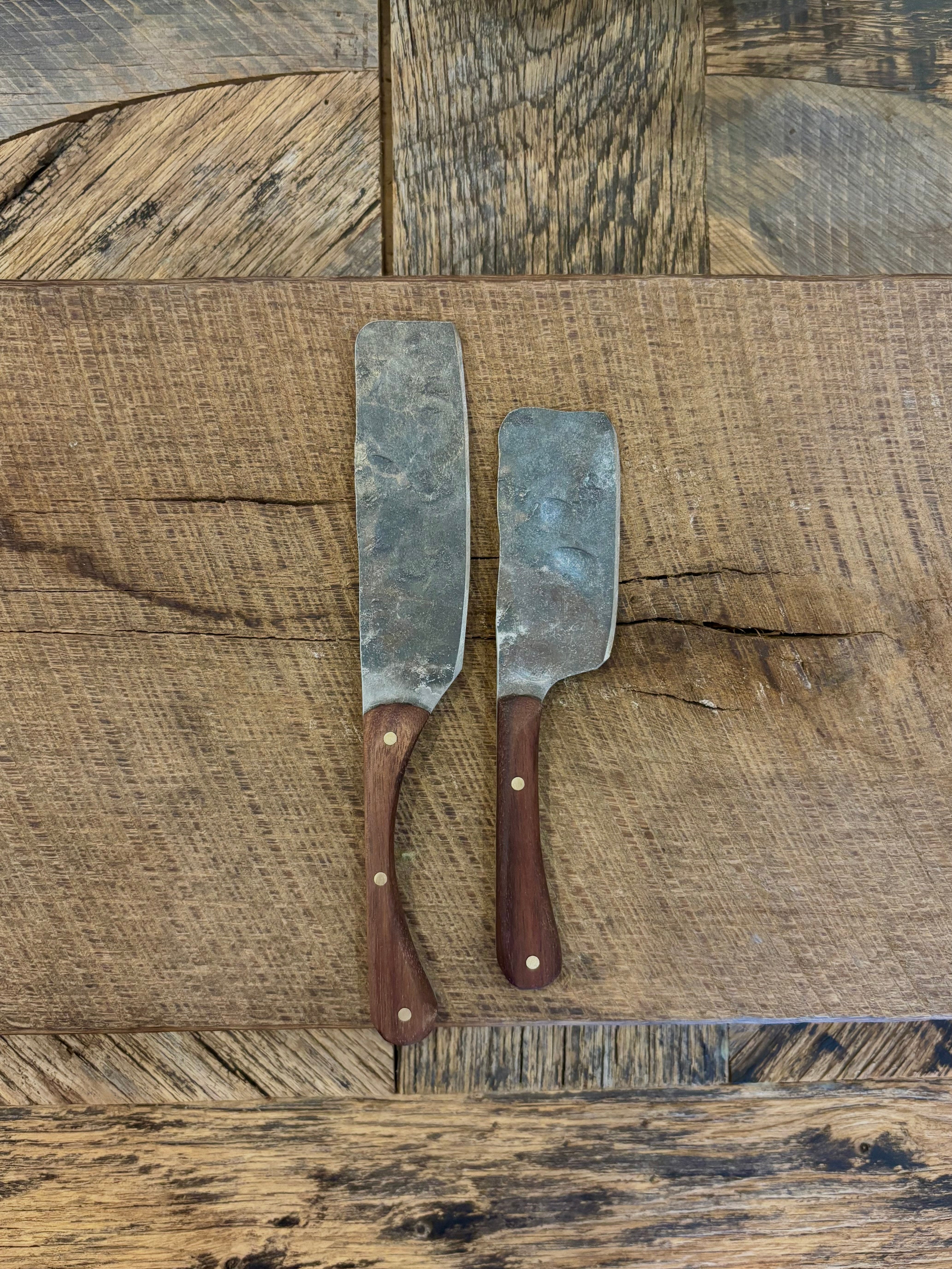 A small and large rustic modern charcuterie serving knife set with hand-forged steel blade and a walnut wooden handle hand crafted in USA