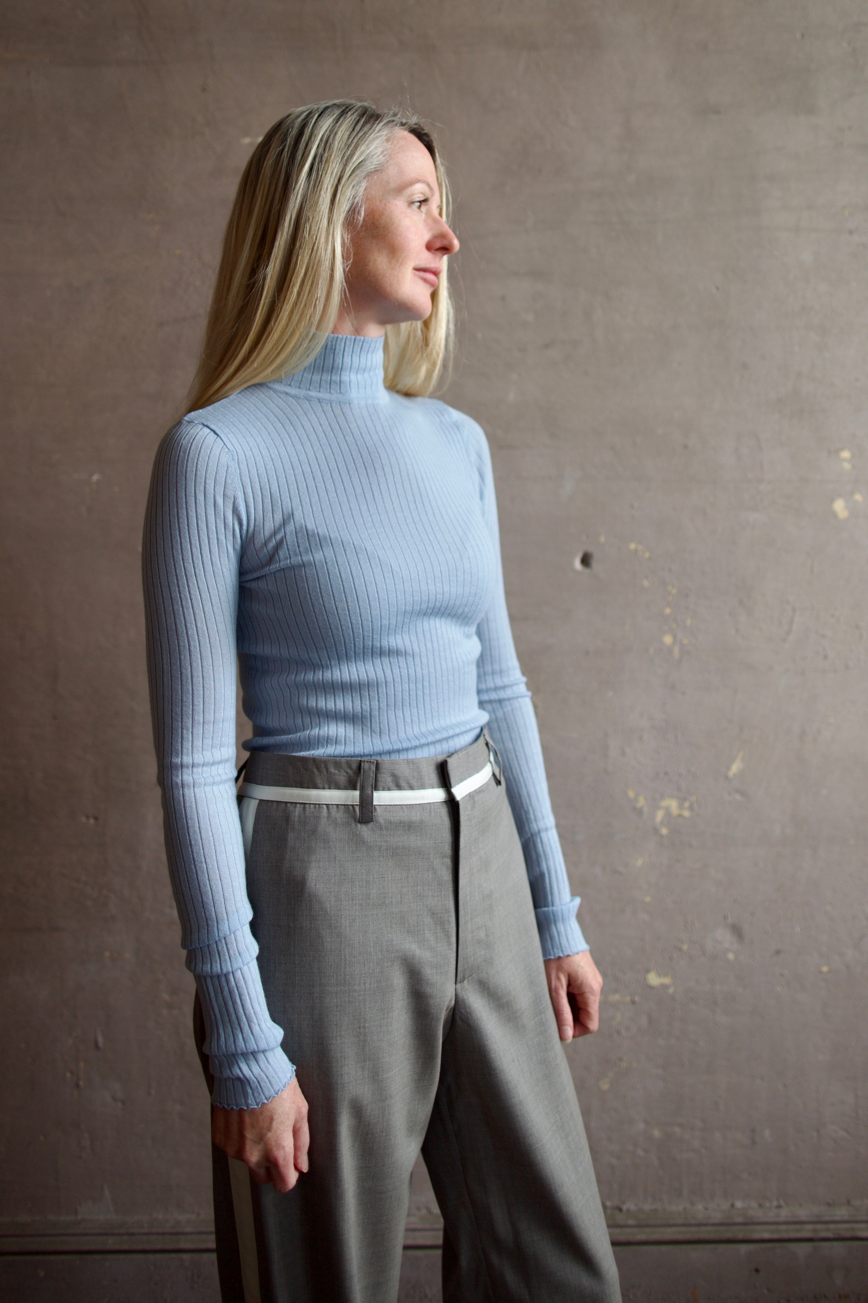Model wearing SPRWMN Baby Blue Mock Neck Cashmere Top - Designer Long Sleeve Ribbed Knitwear