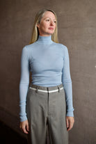 Model wearing SPRWMN Baby Blue Mock Neck Cashmere Top - Designer Long Sleeve Ribbed Knitwear