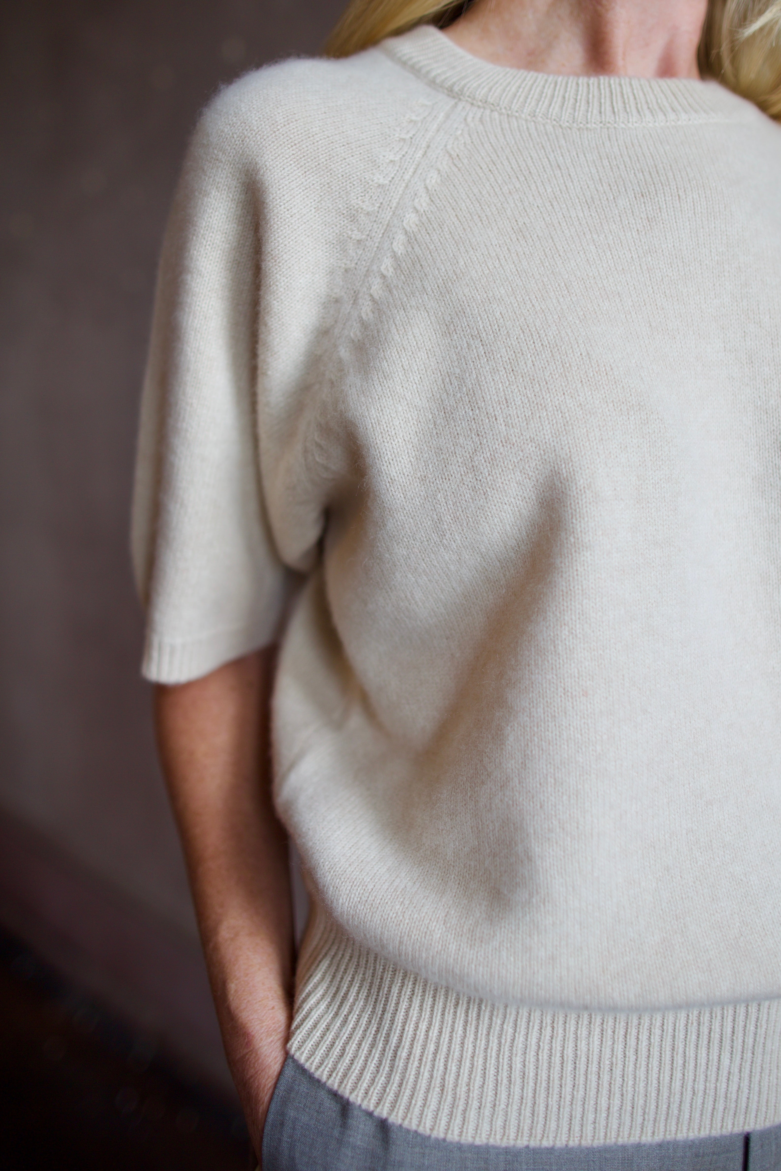 Model wearing luxury brand SPRWMN quality cashmere sweater with fitted ribbed waistband and comfortable relaxed fit