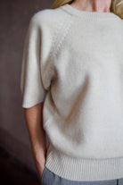 Model wearing luxury brand SPRWMN quality cashmere sweater with fitted ribbed waistband and comfortable relaxed fit