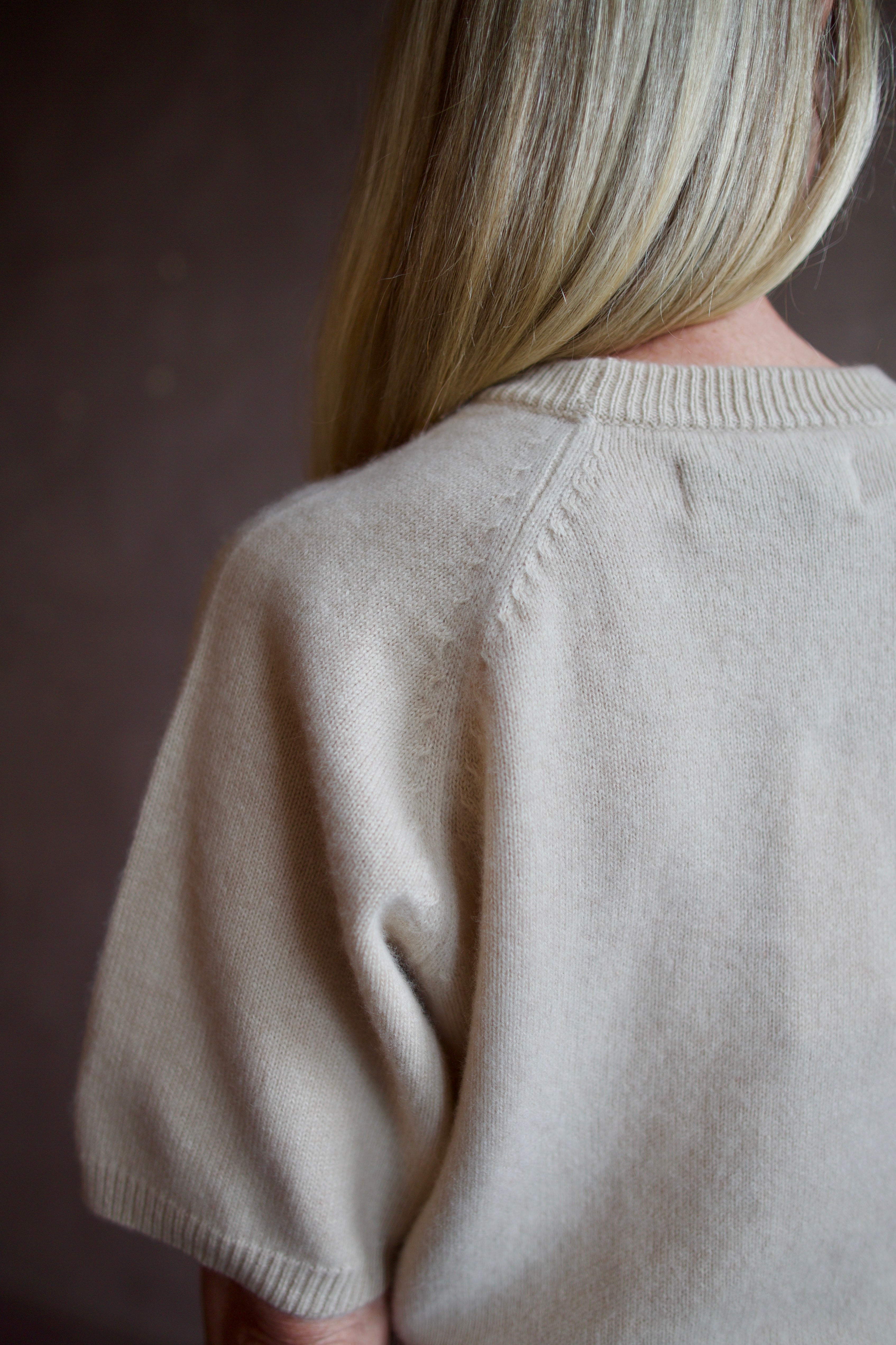 Model wearing luxury brand SPRWMN quality cashmere sweater with fitted ribbed waistband and comfortable relaxed fit