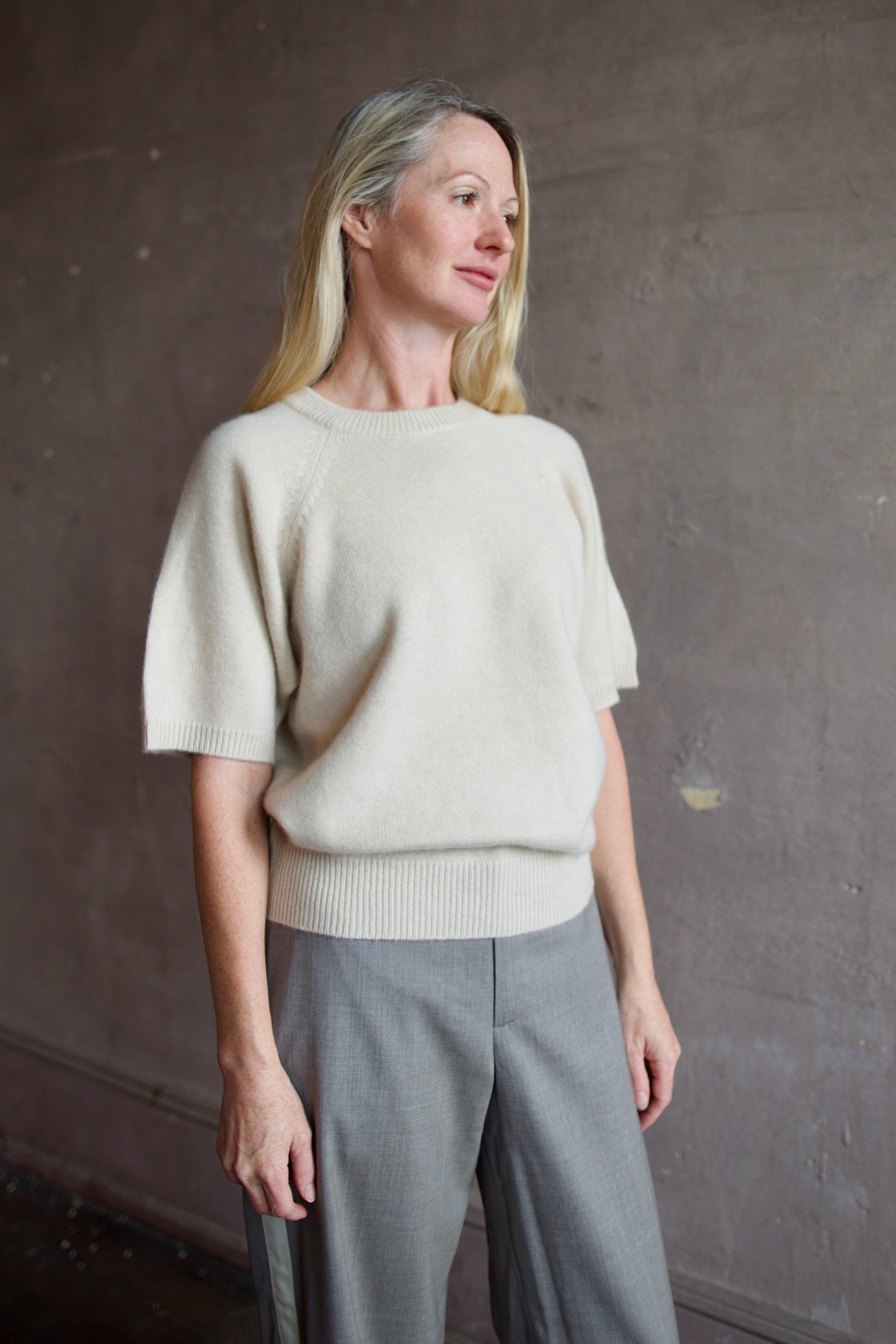 Model wearing luxury brand SPRWMN quality cashmere sweater with fitted ribbed waistband and comfortable relaxed fit