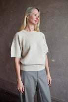 Model wearing luxury brand SPRWMN quality cashmere sweater with fitted ribbed waistband and comfortable relaxed fit