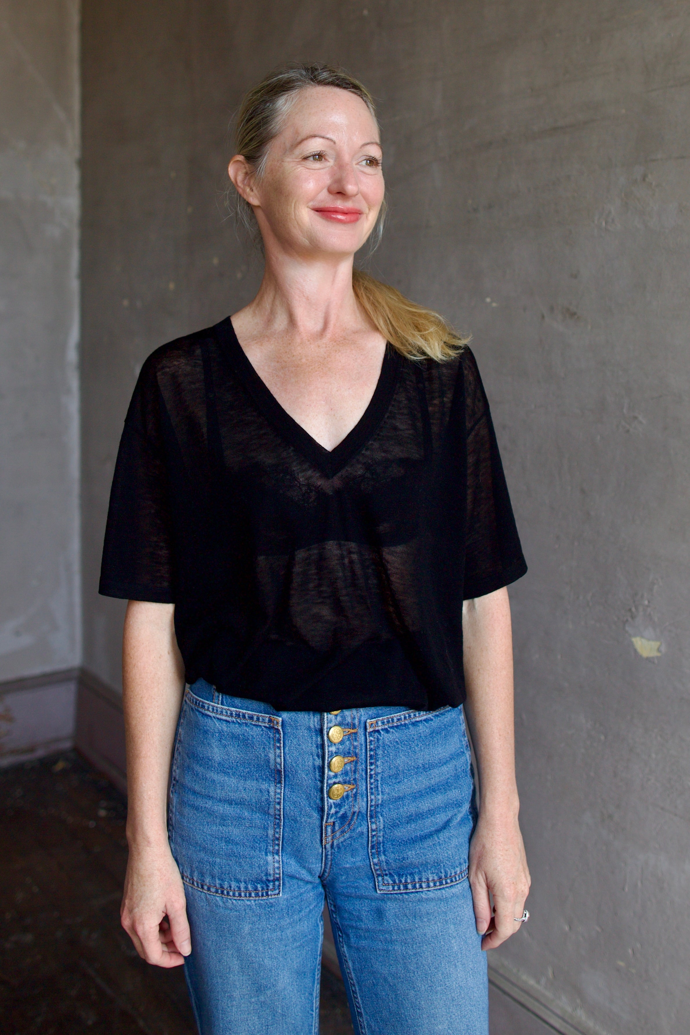 Model wearing SPRWMN Black V Neck Wool Tee - Designer Sheer Wool Short Sleeve Top