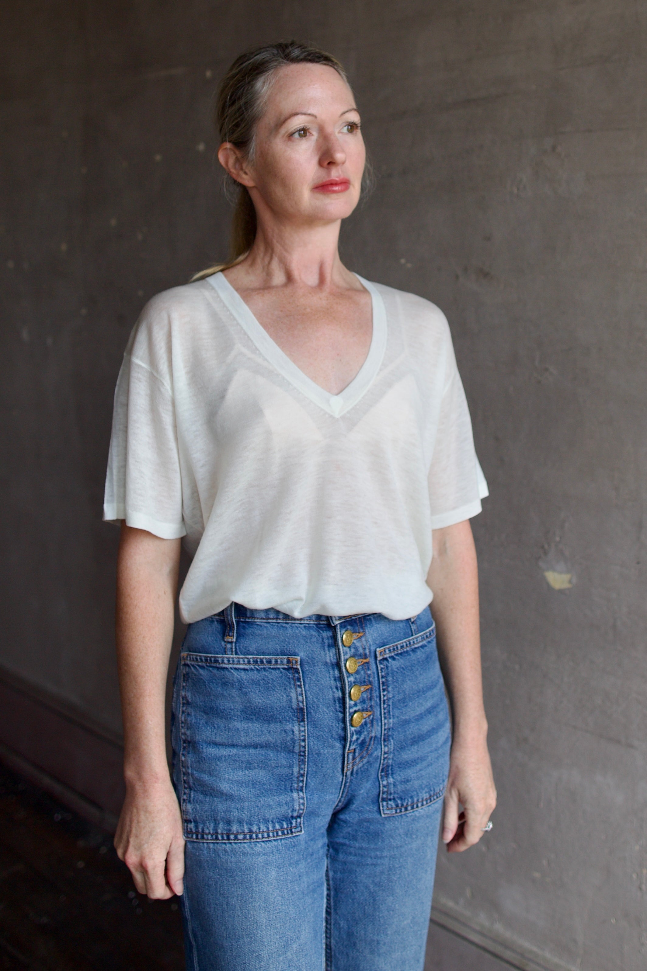 Model wearing SPRWMN Ivory V Neck Wool Tee - Designer Sheer Wool Short Sleeve Top