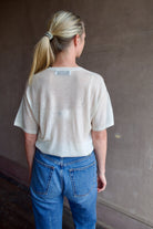Model wearing SPRWMN Ivory V Neck Wool Tee - Designer Sheer Wool Short Sleeve Top