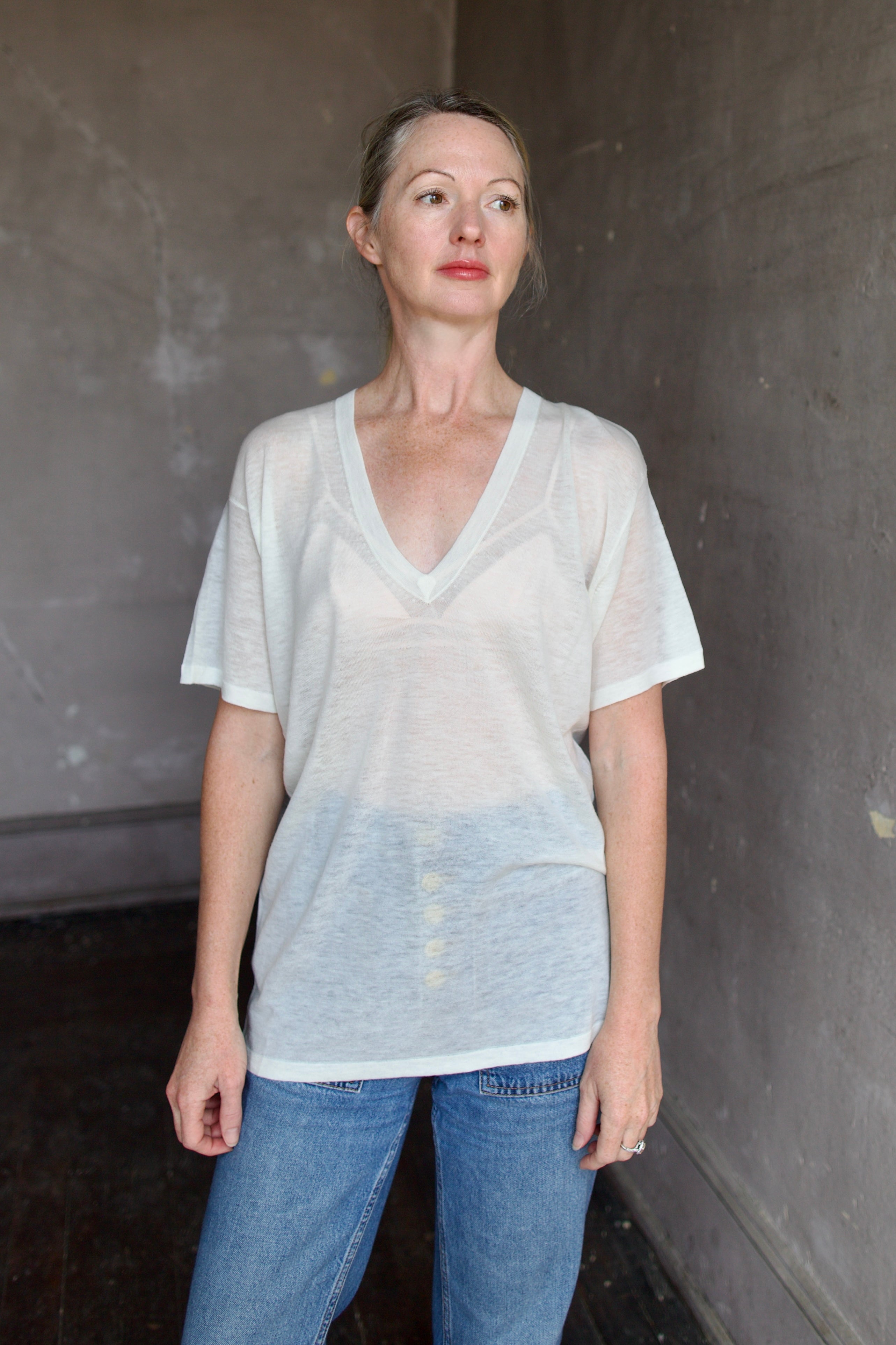 Model wearing SPRWMN Ivory V Neck Wool Tee - Designer Sheer Wool Short Sleeve Top