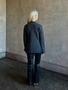 Mature woman wearing SPRWMN Black Ankle Flare Leather Pants Designer Mid-Rise Stretch Leather 