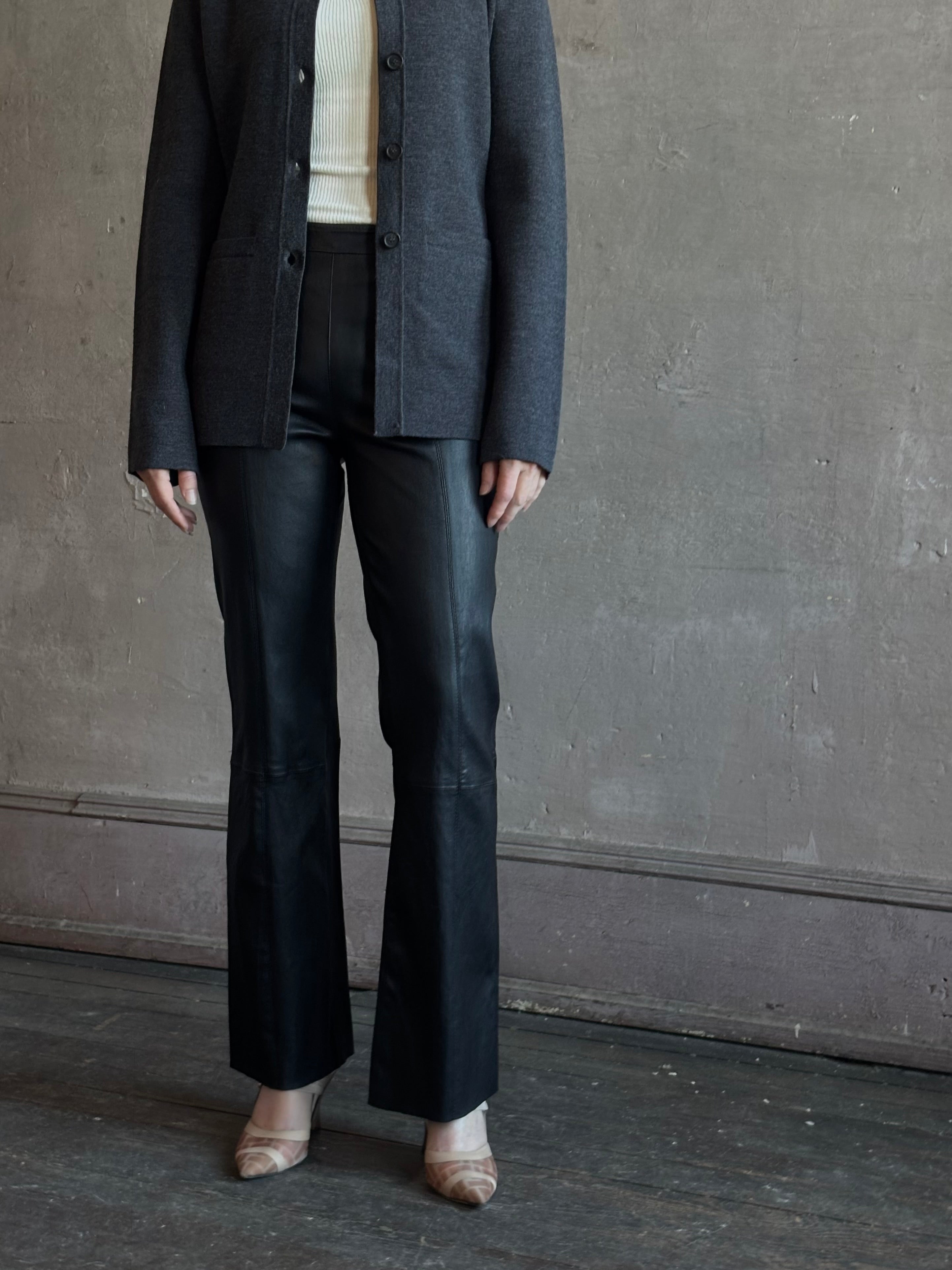 Mature woman wearing SPRWMN Black Ankle Flare Leather Pants Designer Mid-Rise Stretch Leather 