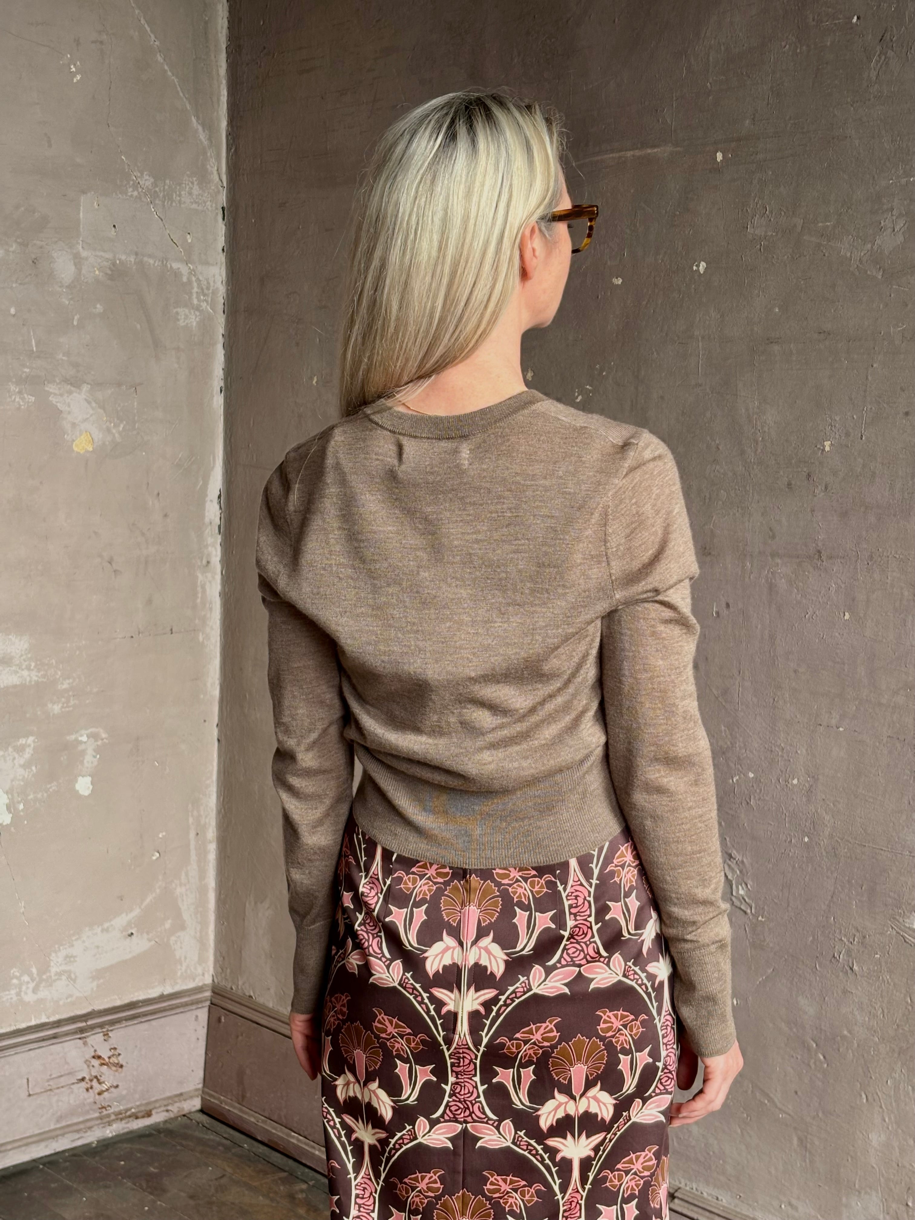 Mature woman wearing designer SPRWMN brown knit cashmere button front layering or stand alone baby cardigan 
