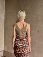 Mature woman wearing SPRWMN camille truffle tank front and back V-necklines in a rolled ege lightweight cashmere