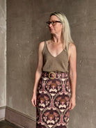 Mature woman wearing SPRWMN camille truffle tank front and back V-necklines in a rolled ege lightweight cashmere