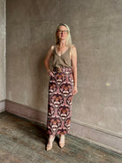 Mature woman wearing SPRWMN camille truffle tank front and back V-necklines in a rolled ege lightweight cashmere