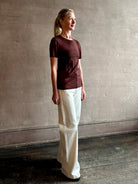 Image of woman wearing premium polished layer SPRWMN classic brown wool tee shirt with crew neck and short sleeve