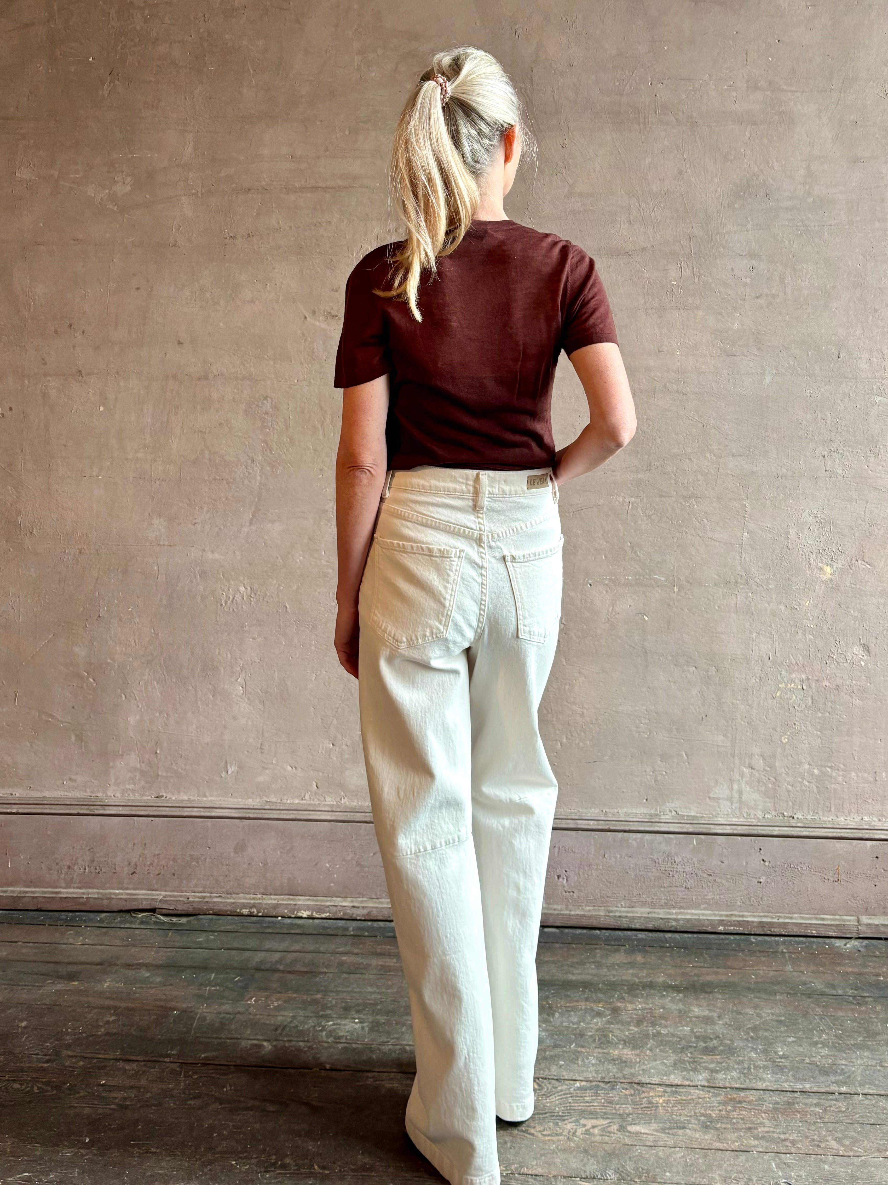 Image of woman wearing premium polished layer SPRWMN classic brown wool tee shirt with crew neck and short sleeve